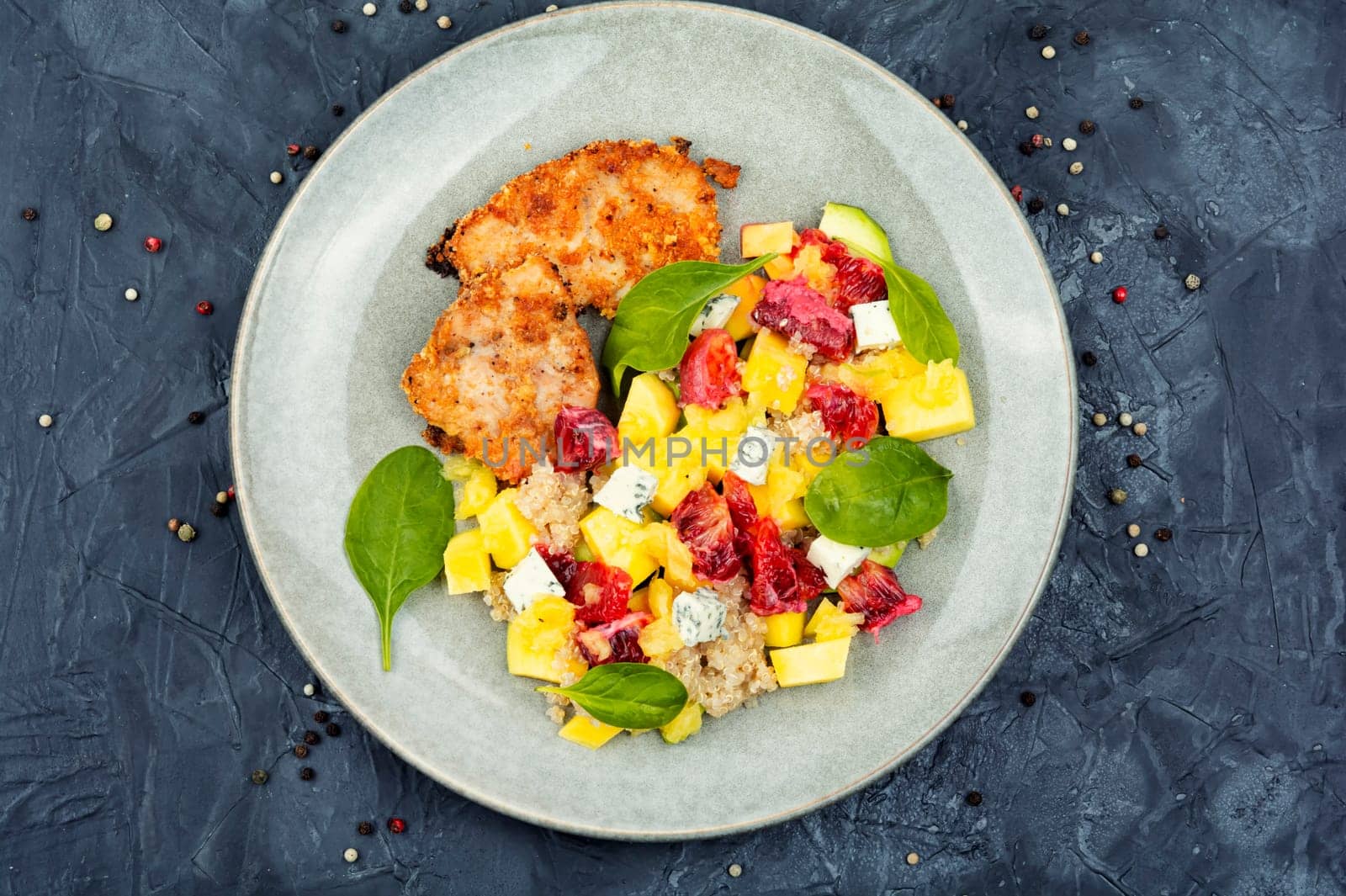 Tasty salad with fruit, chicken fillet and quinoa. Detox diet