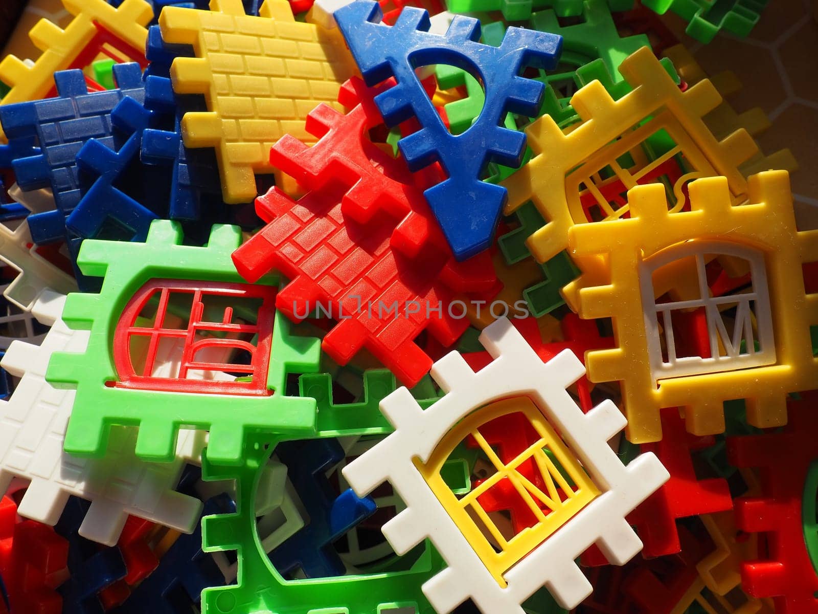 children's designer toy. Plastic bright multi-colored blocks for playing and developing the imagination and fine motor skills of the child's hands. Toy house construction.