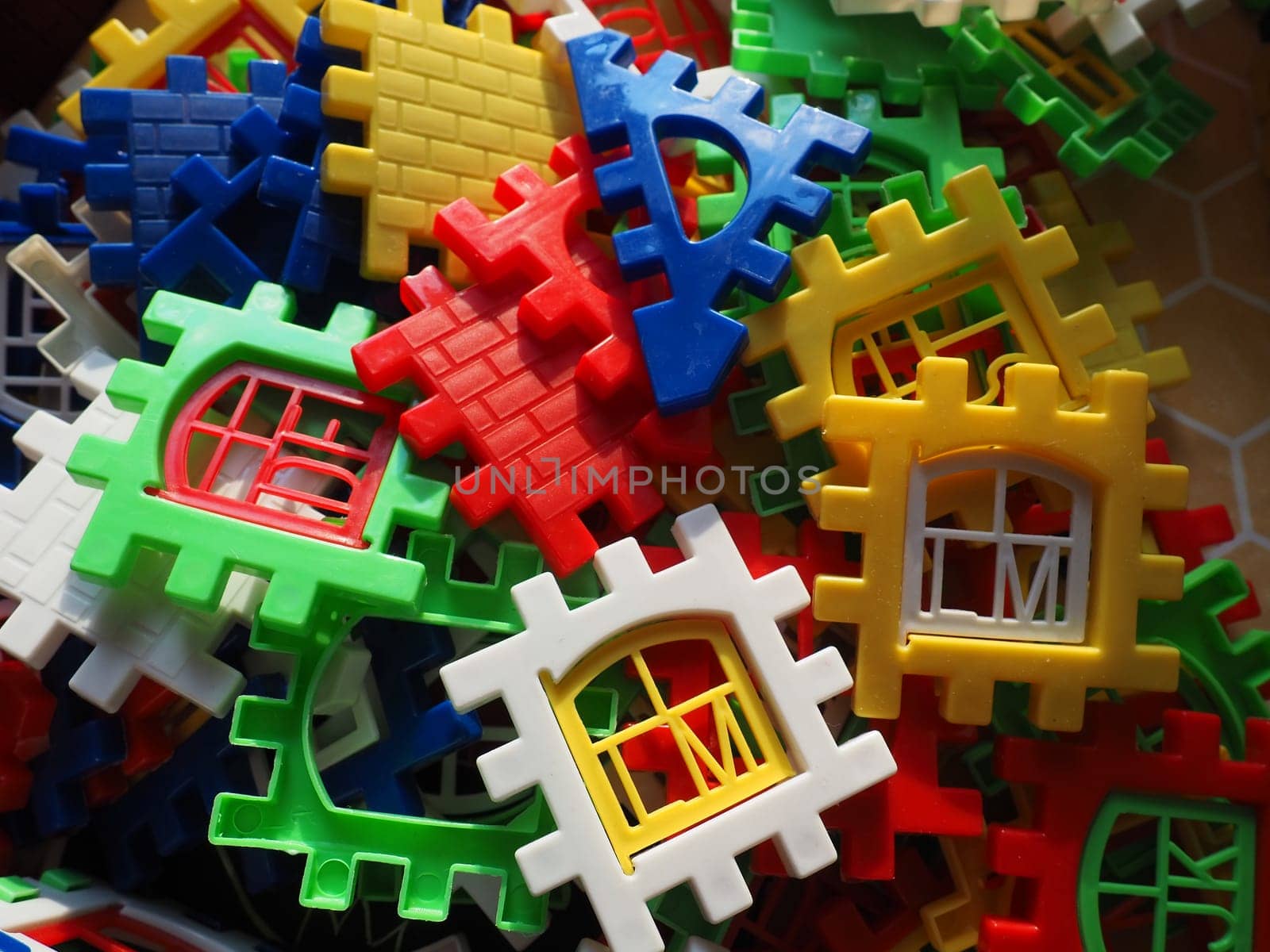 children's designer toy. Plastic bright multi-colored blocks for playing and developing the imagination and fine motor skills of the child's hands. Toy house construction.