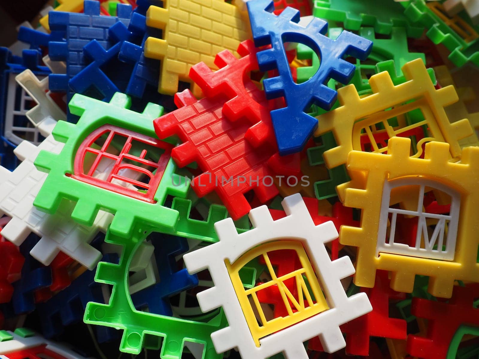 children's designer toy. Plastic bright multi-colored blocks for playing and developing the imagination and fine motor skills of the child's hands. Toy house construction.
