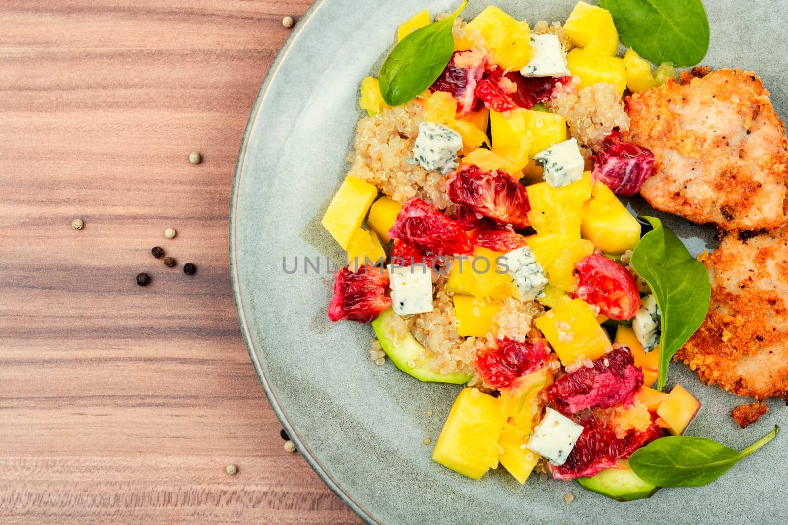Tasty salad with fruit, chicken fillet and quinoa. Detox diet