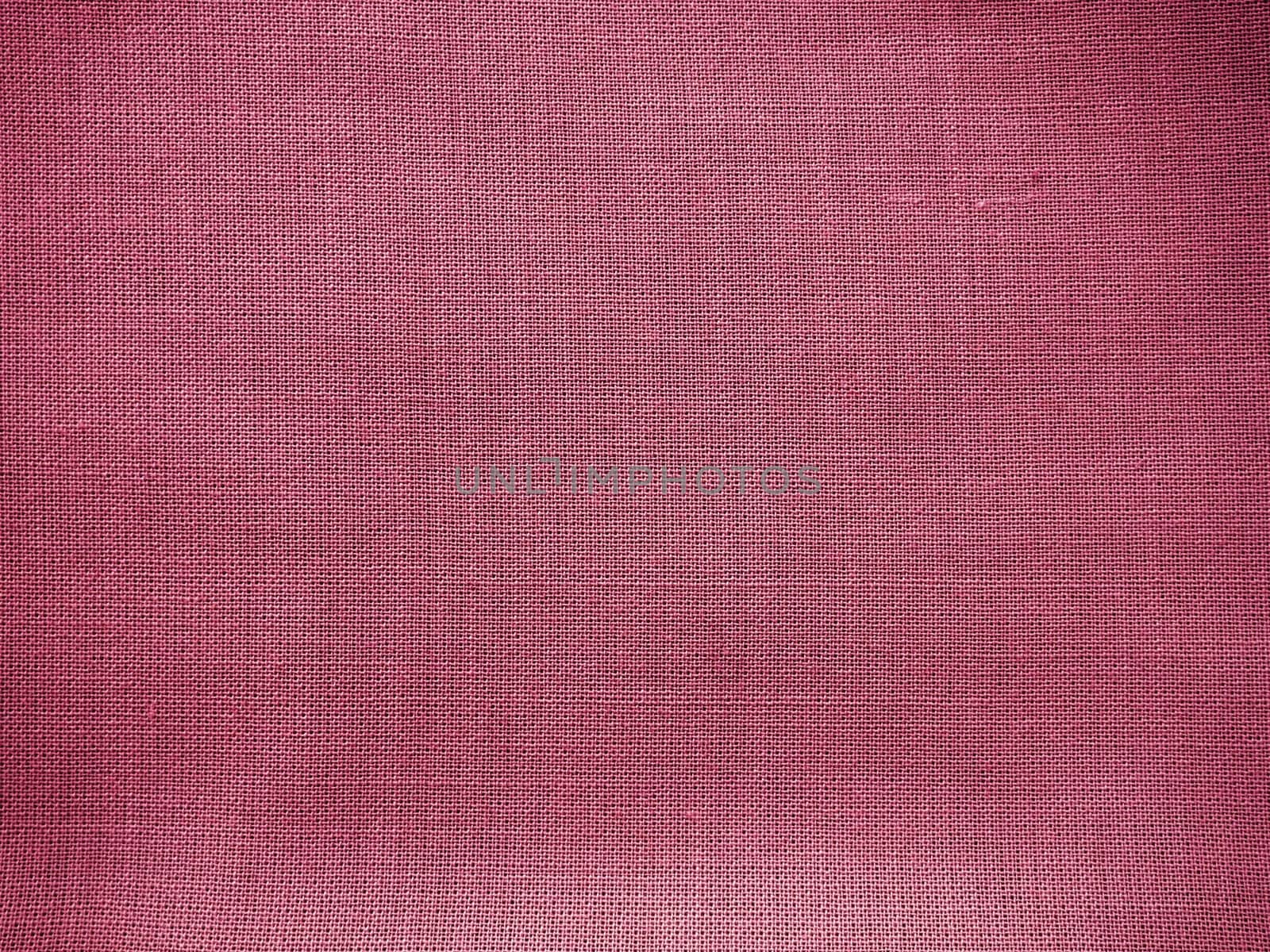Cloth close-up. Interlacing of threads. A piece of pink fabric. Fabric background. Copy space.