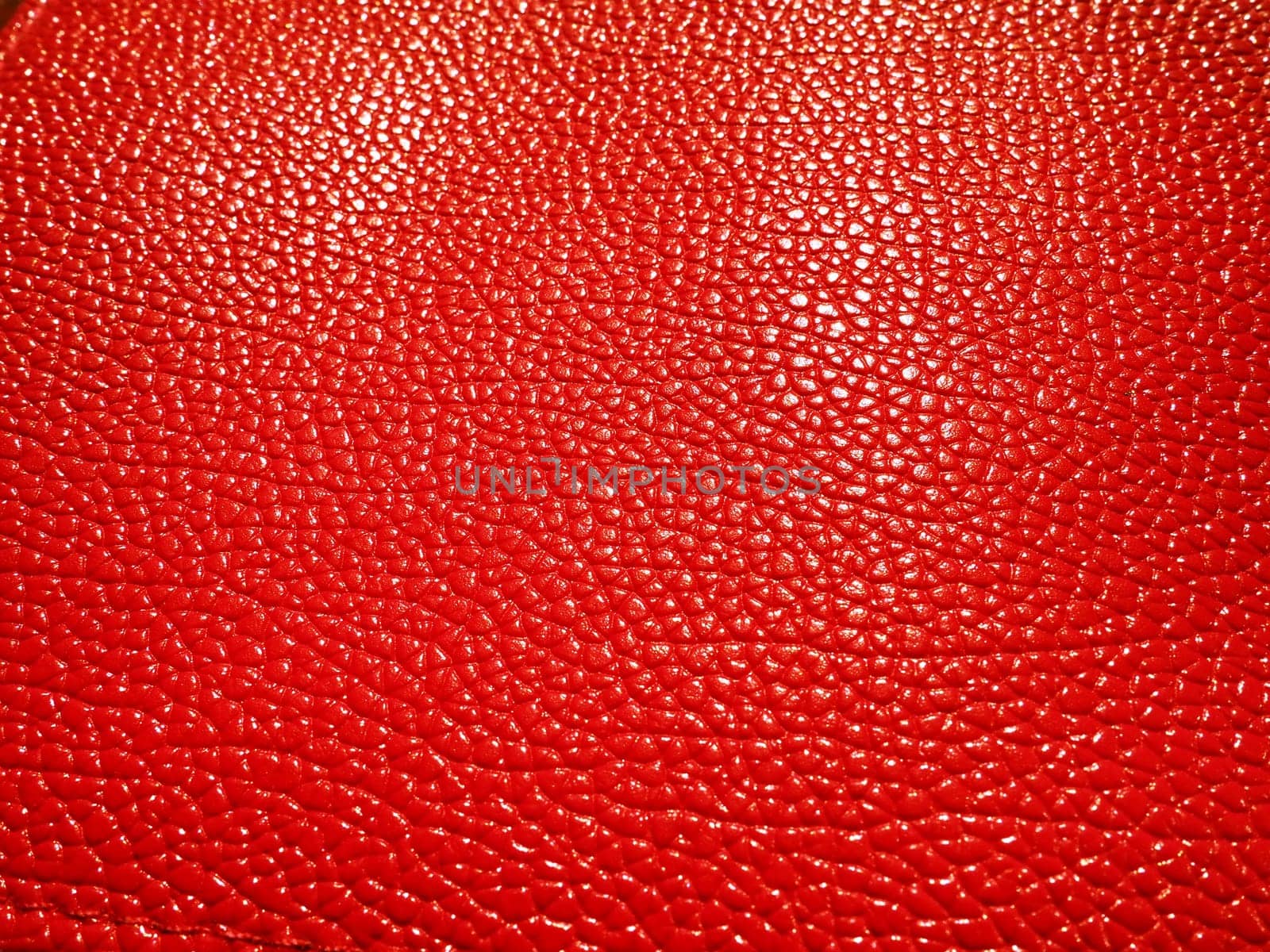 Red or pink leather. Material for fashion accessories, for sewing leather and suede products, furniture upholstery. Natural leather texture. Magenta or fuchsia
