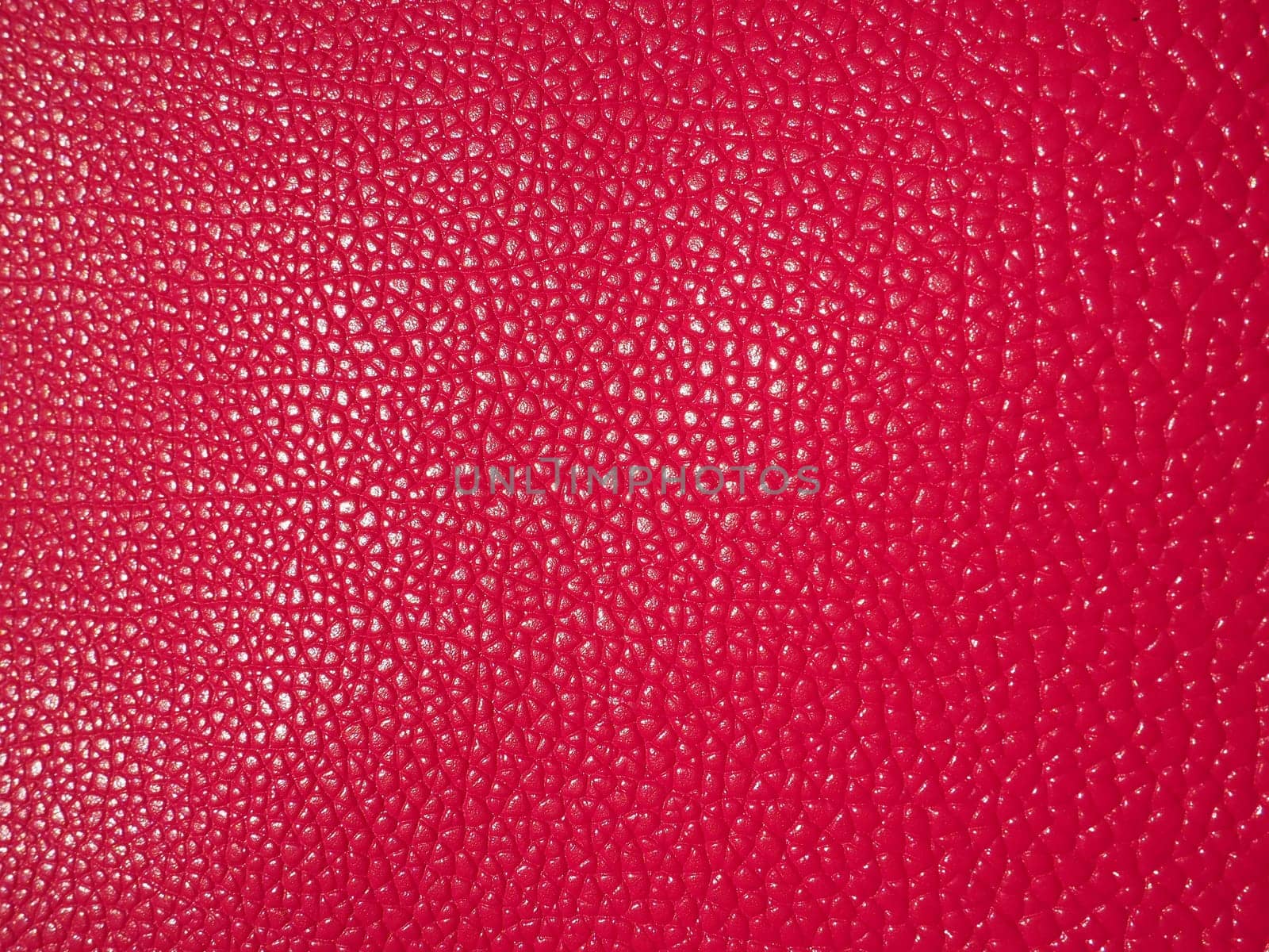 Red or pink leather. Material for fashion accessories, for sewing leather and suede products, furniture upholstery. Natural leather texture. Magenta or fuchsia