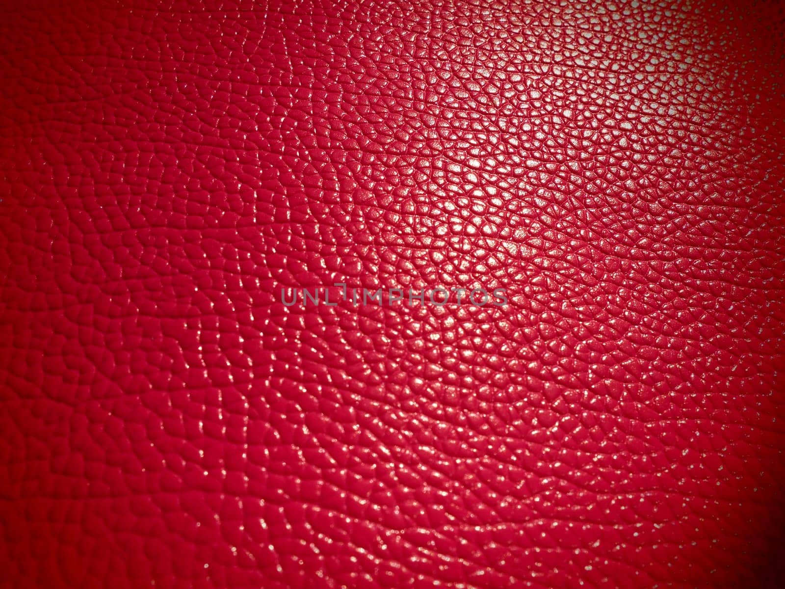Red or pink leather. Material for fashion accessories, for sewing leather and suede products, furniture upholstery. Natural leather texture. Magenta or fuchsia.