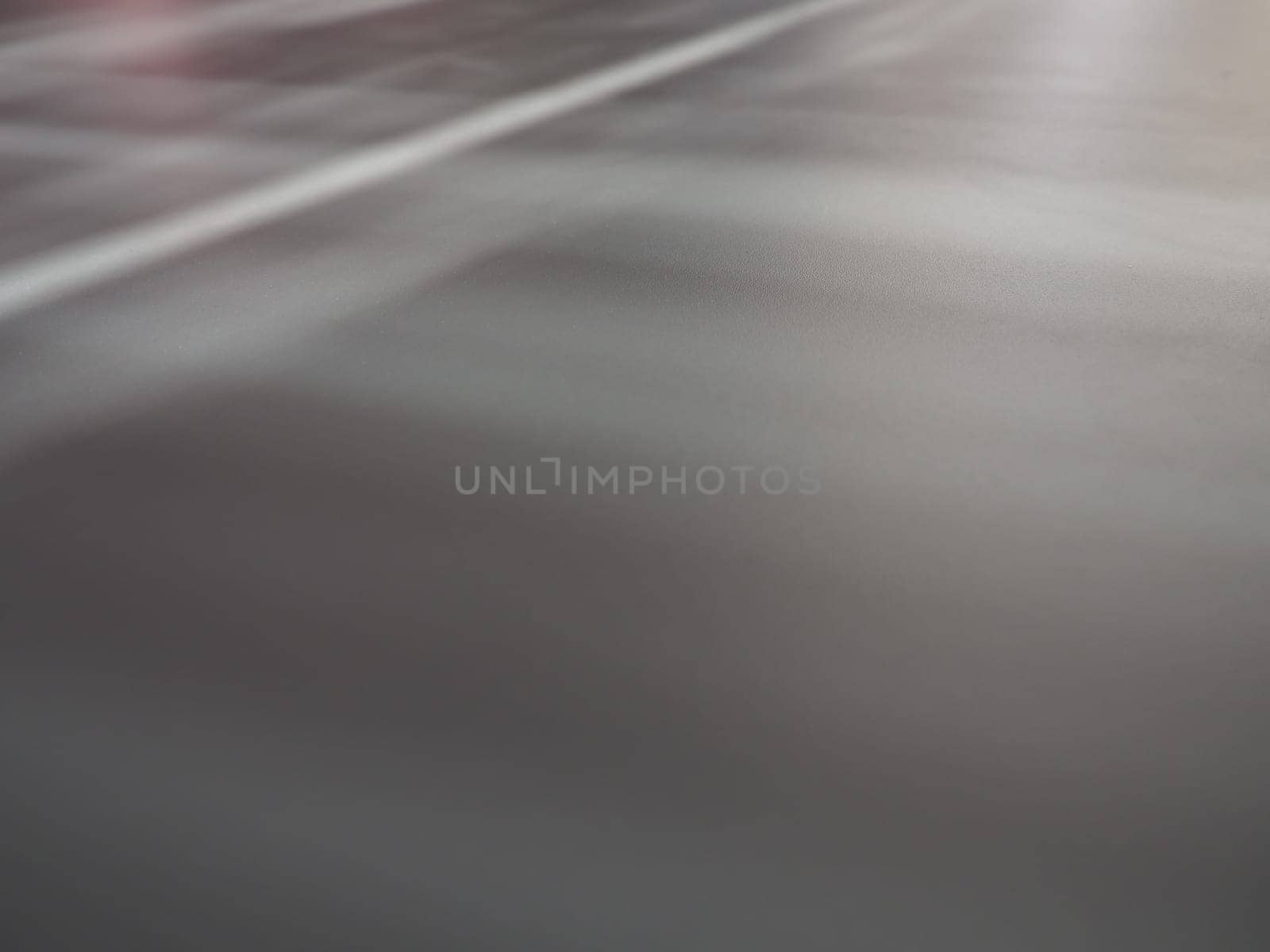 Illumination rays on gray surface. Abstract rays of light and lens flare on a gray background. Vertical, horizontal and diagonal light stripes.
