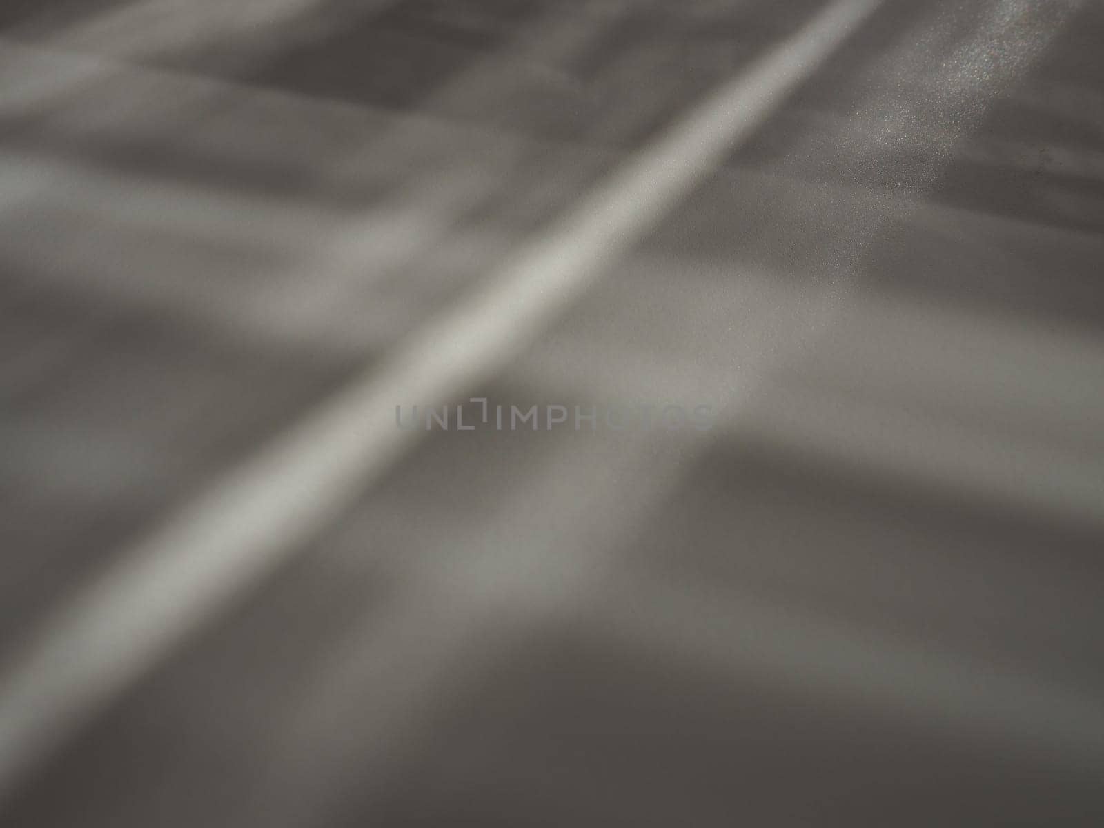 Illumination rays on gray surface. Abstract rays of light and lens flare on a gray background. Vertical, horizontal and diagonal light stripes.