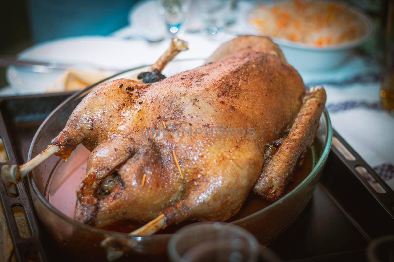 Cooked baked goose or turkey on baking sheet, on table