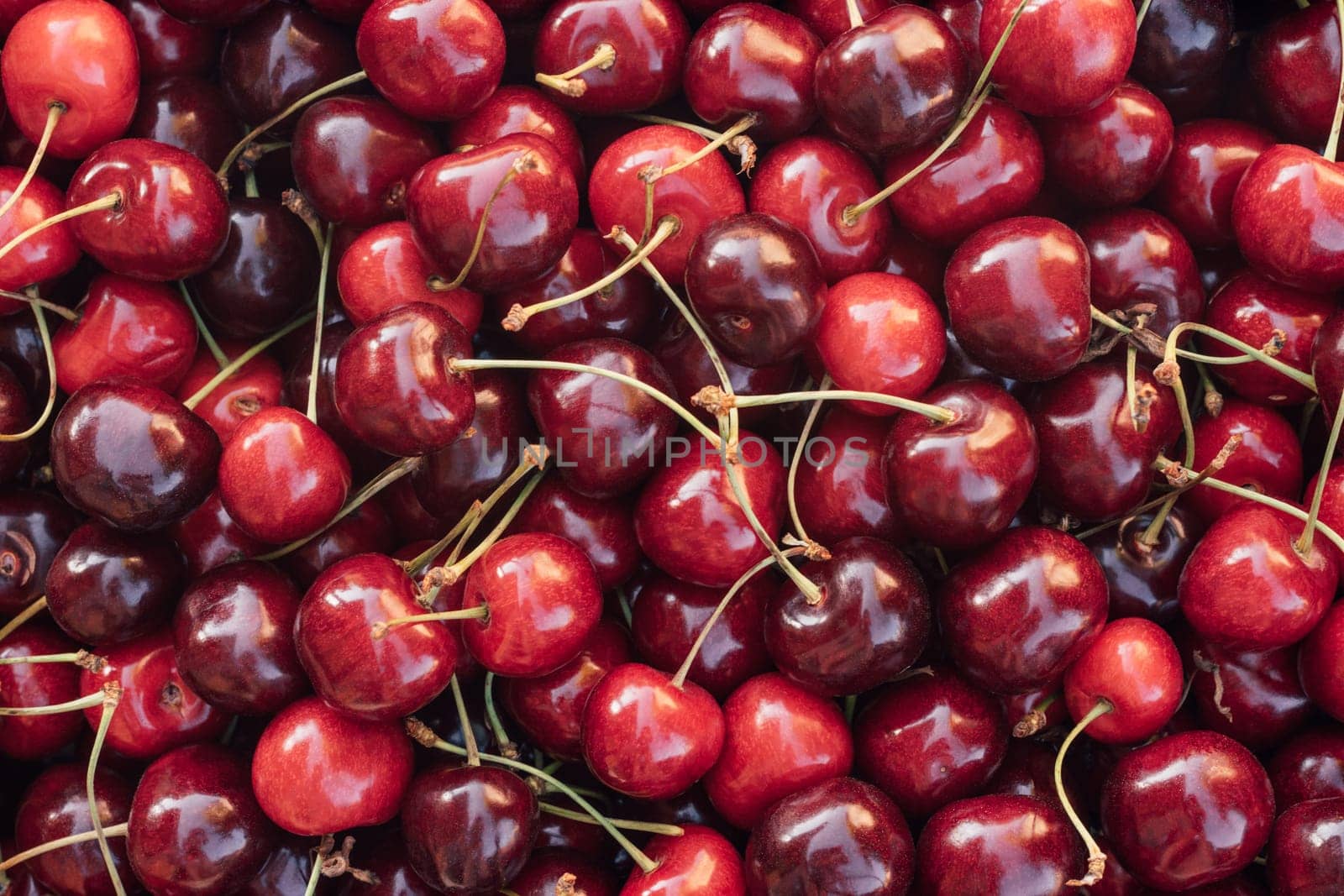 Background image of lying red ripe sweet cherries. Top view. Flat lay. Copy space