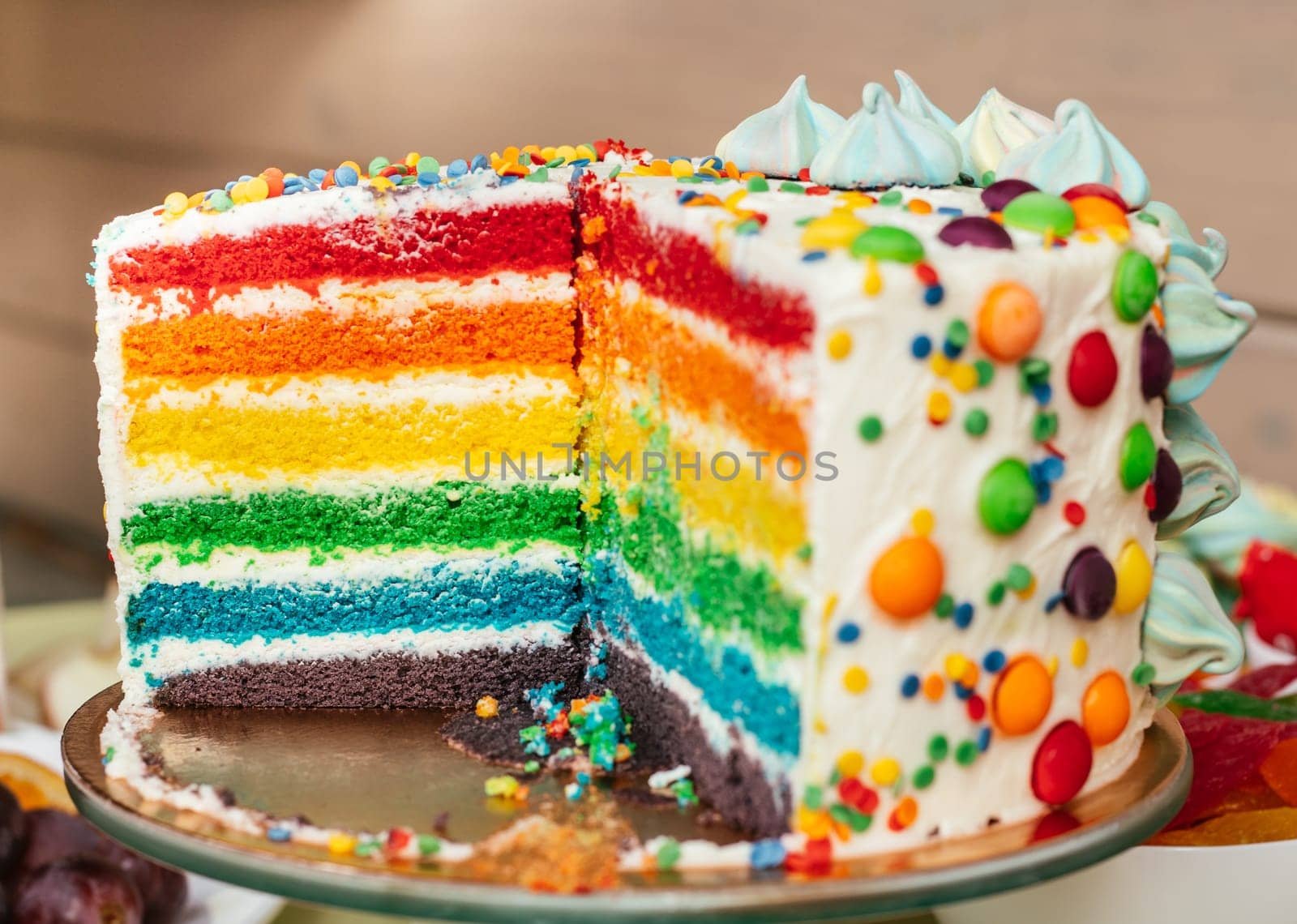 Sliced multicolored rainbow cake. Cake with layers of bright colors inside