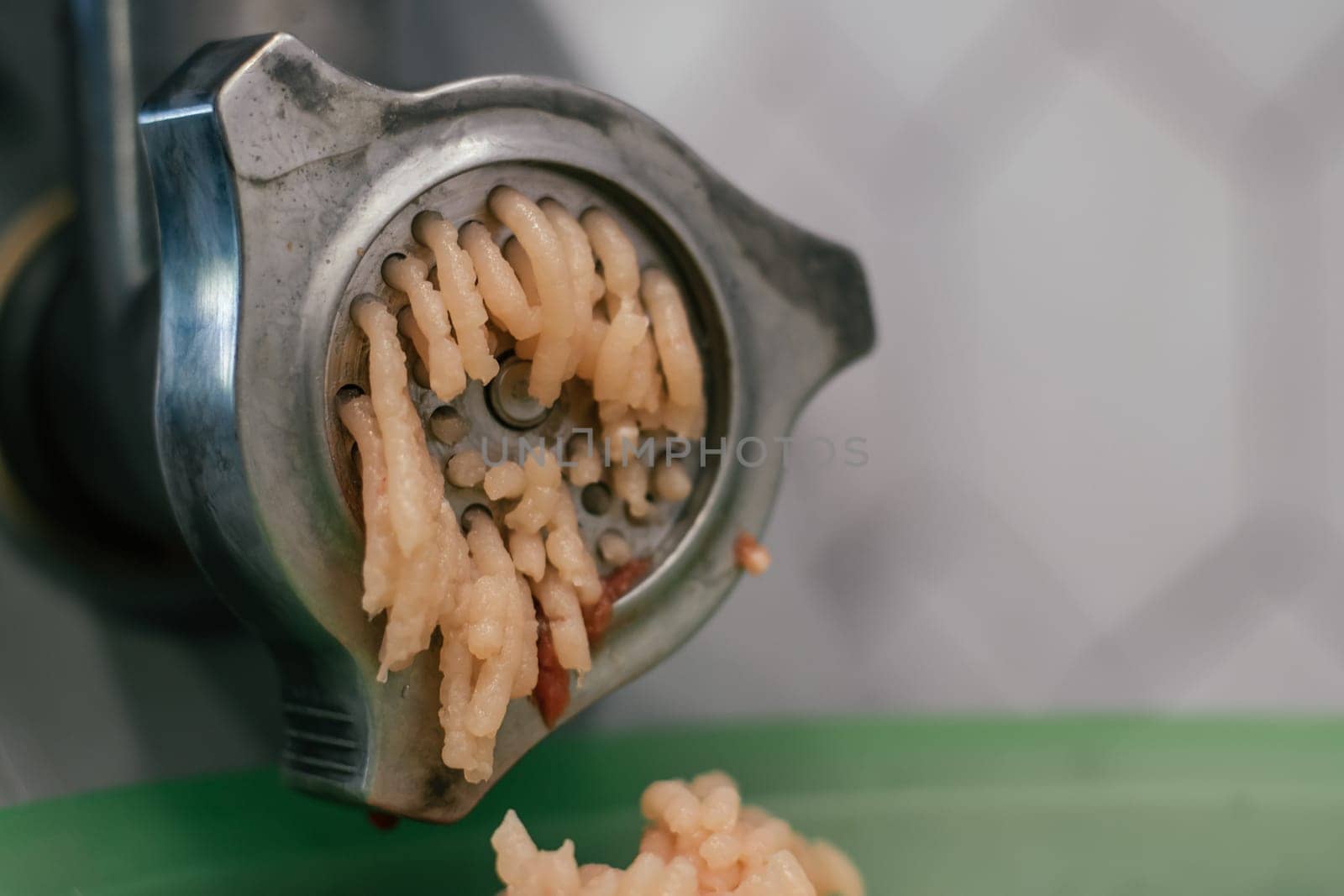 Minced fresh raw meat in meat grinder scrolls. Animal product. Production and consumption factory of meat pork, lamb, chick, beef. Culinary cook ingredient recipe nutrient. Chopped Food. Close up