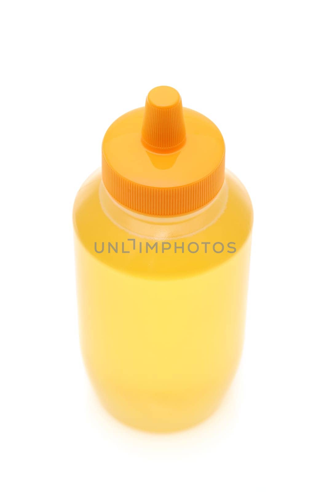 Plastic bottle of honey on white background