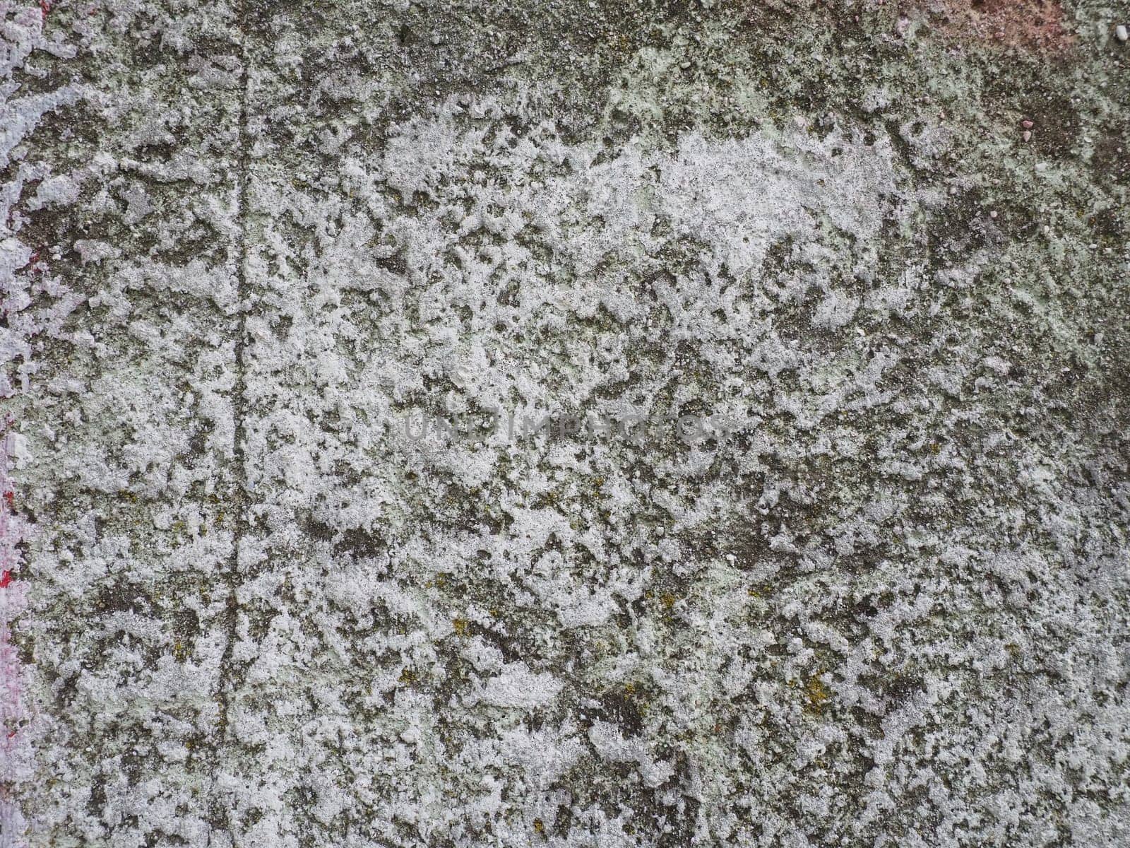 Concrete texture. Concrete wall with white paint. A casually painted wall. Translucent gray plaster through the applied oil paint. Grunge background with blank space. Copy space. Popcorn - plaster.
