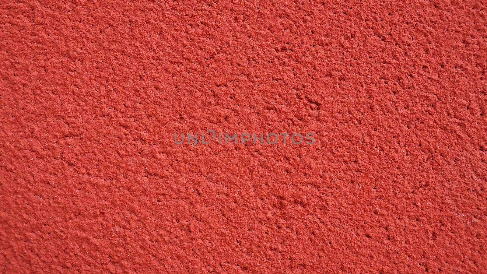 Background, texture of cement plaster of red color. Plastering of internal premises and external facades of buildings. Interior in red