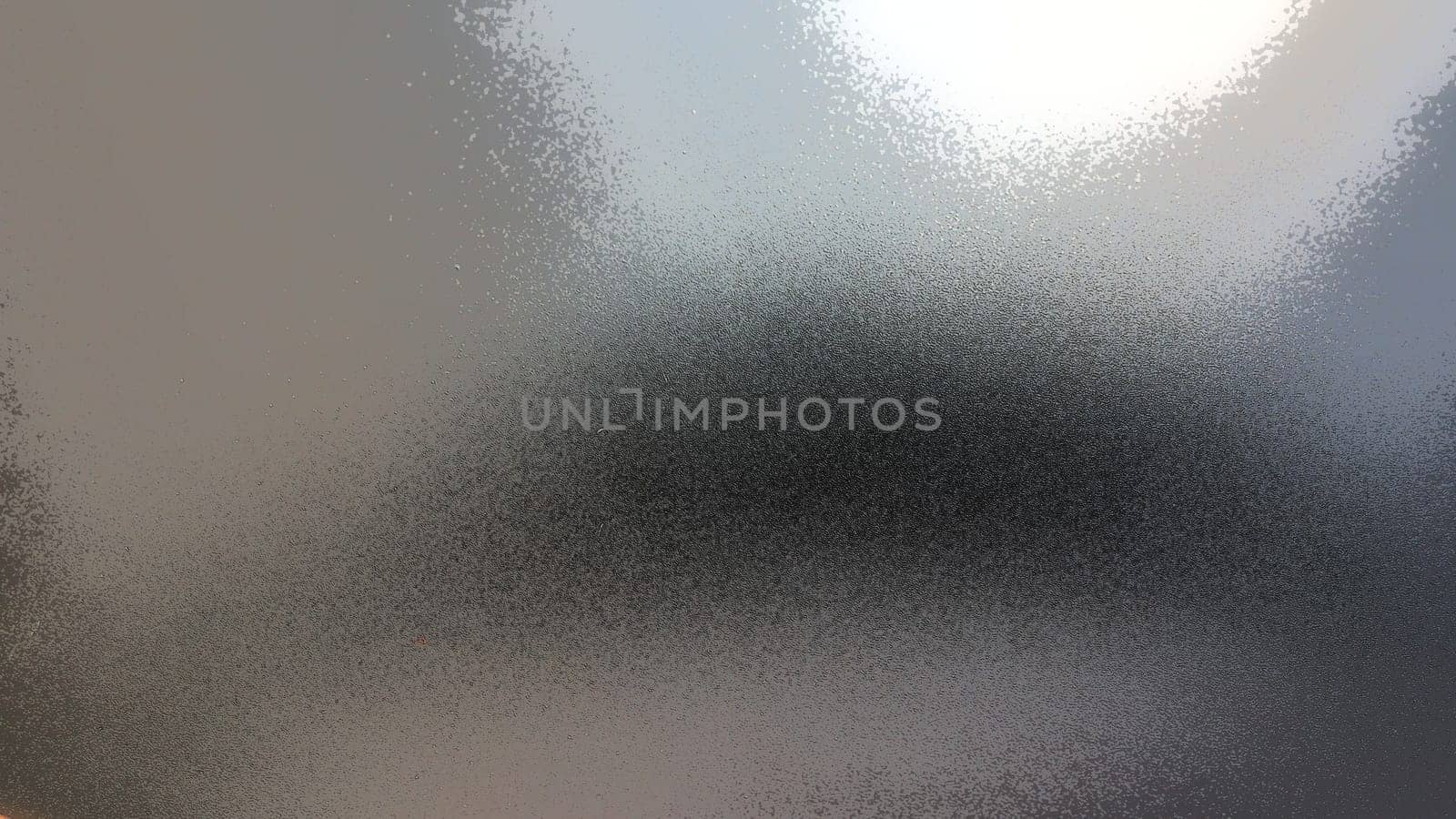 Abstract gray background with gradient, coarse grain. Selective focus. Blurred backdrop with dots and glow