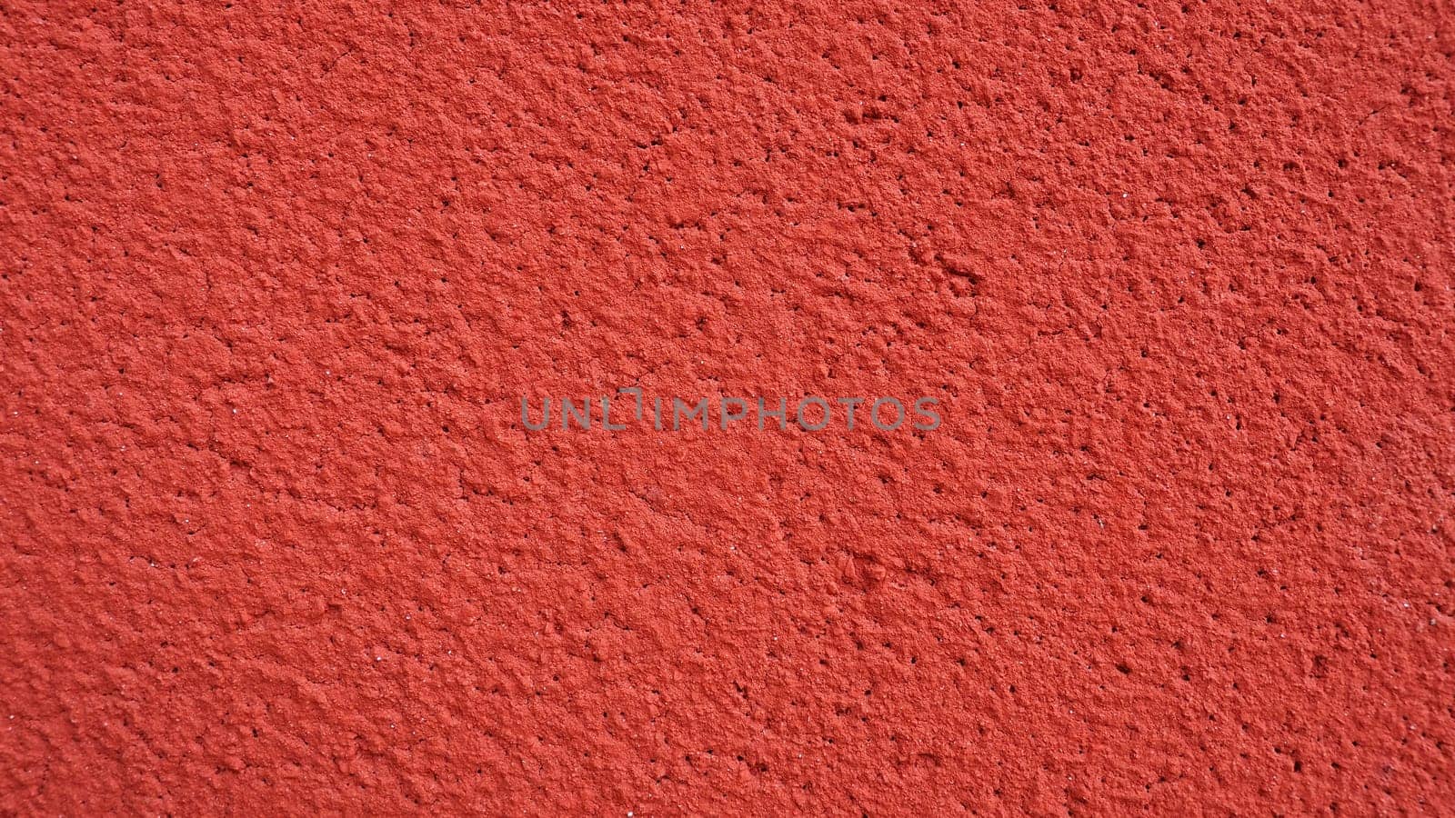 Background, texture of cement plaster of red color. Plastering of internal premises and external facades of buildings. Interior in red
