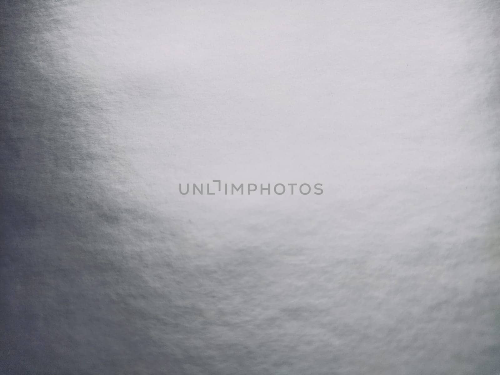 silver gray background with gradient. Light reflective colored paper with a metallic sheen. Background.
