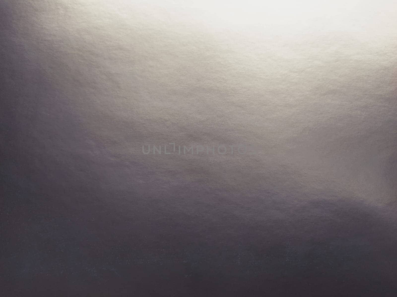 silver gray background with gradient. Light reflective colored paper with a metallic sheen. Background.