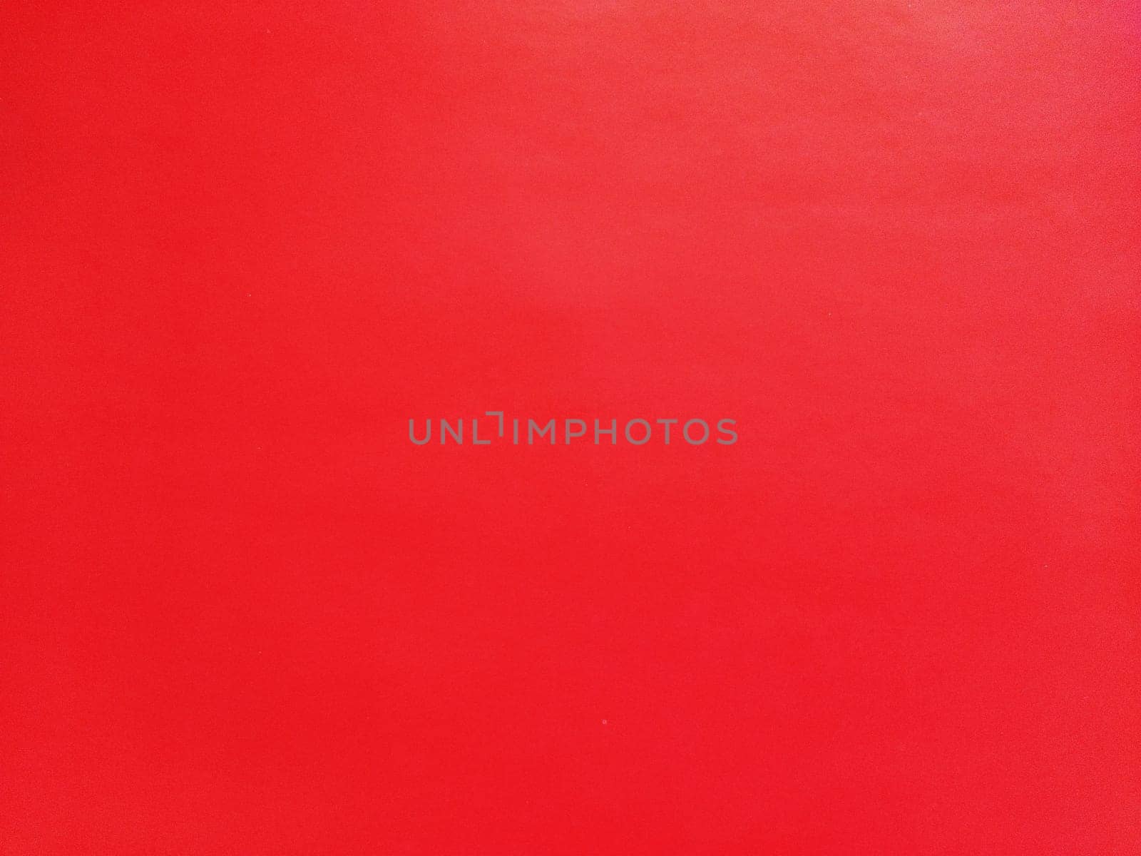 abstract red background or Christmas paper texture. Red base for cards for Valentine's Day, New Year, or Christmas. Color gradient.