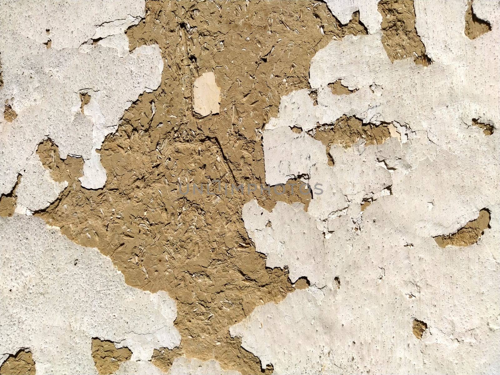 Close-up background of the wall of an old house made of clay mixed with straw. Old type of construction. Clay wall of straw and mud. Manure mixed with clay and dried as building material.