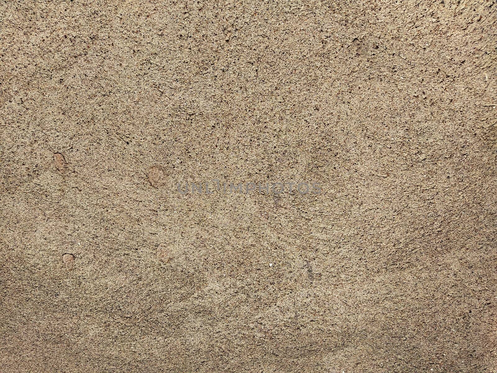 Concrete background of beautiful natural color of crushed stone. Fine ripples of ground sand and gravel. Gray and beige colors. The background. Copy space.