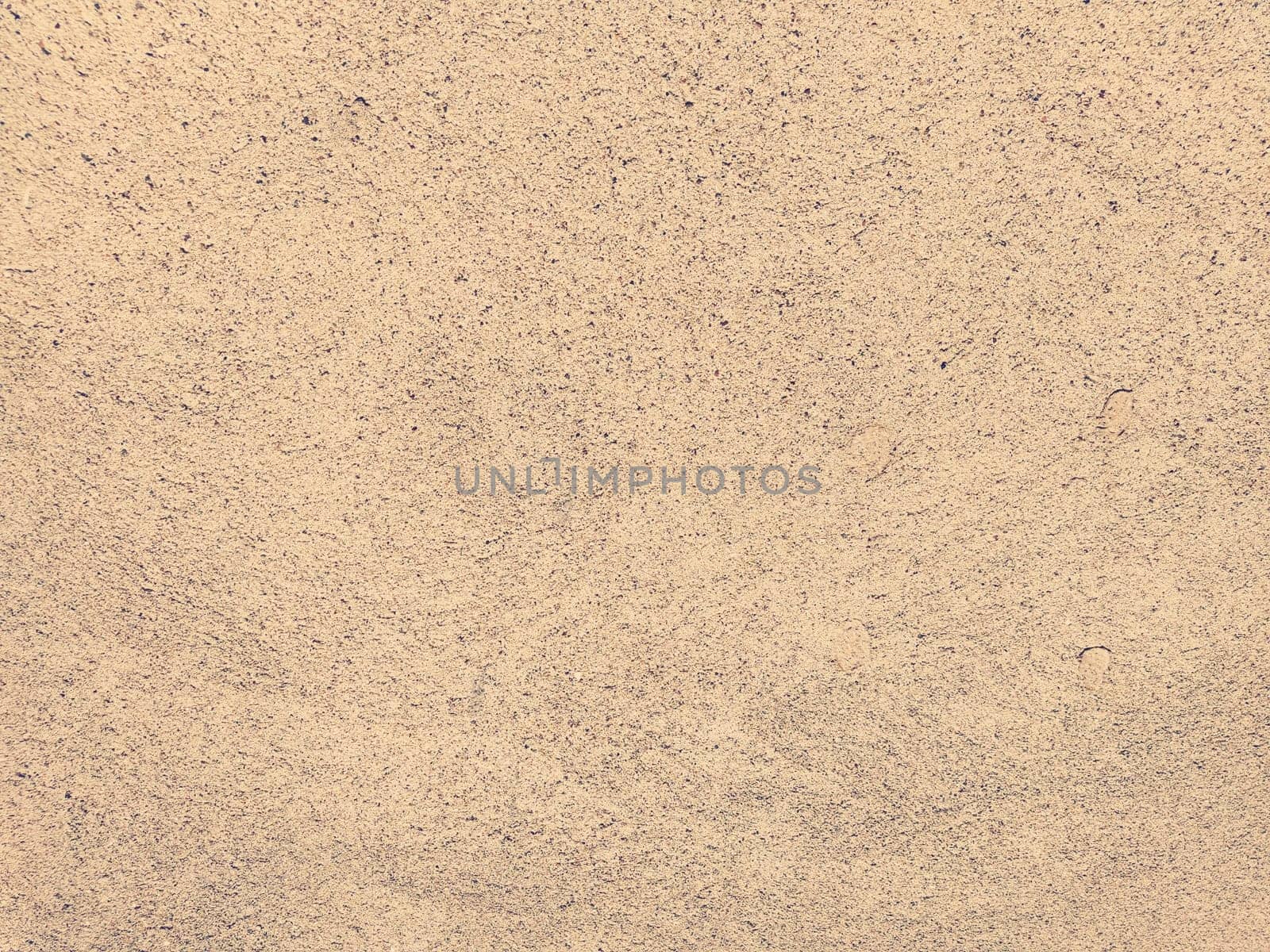 Concrete background of beautiful natural color of crushed stone. Fine ripples of ground sand and gravel. beige color. The background. Copy space.