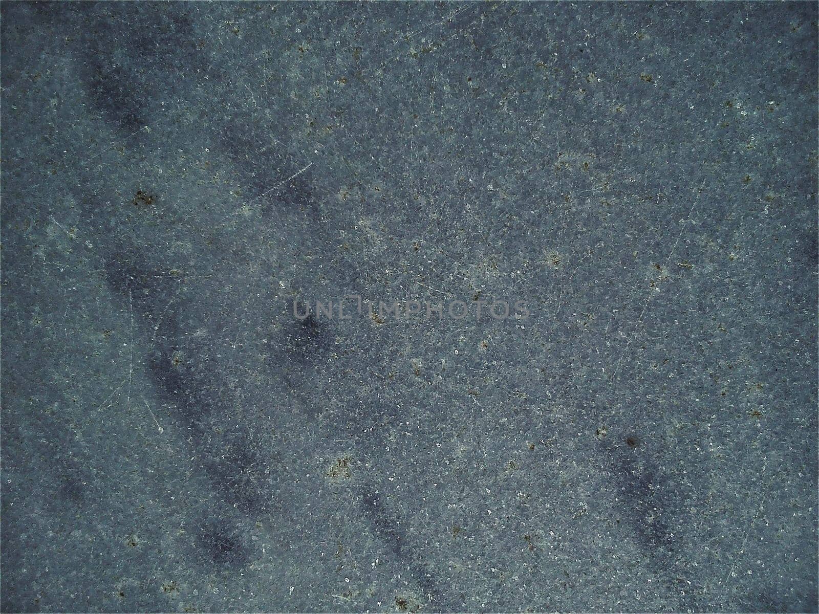 Granite smooth surface or slab of languid gray color with black spots and dots. Variant of interior decoration. Close-up. Natural background. Stone cutting.