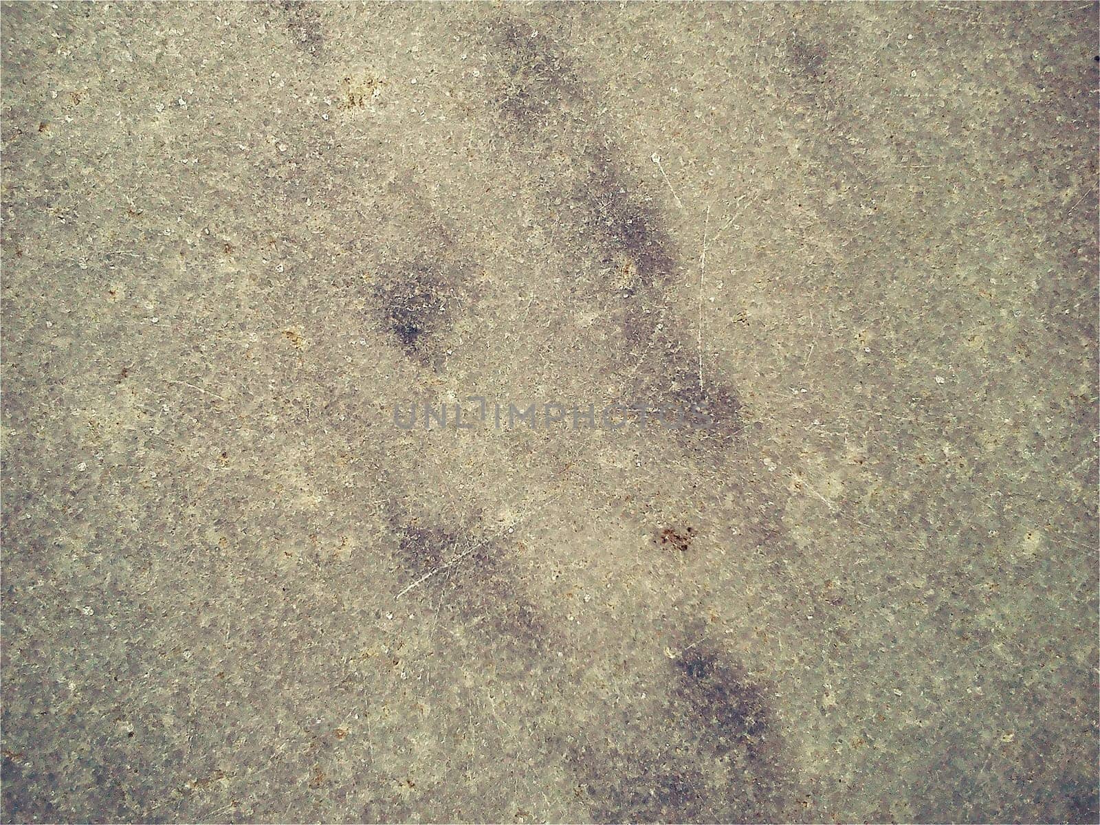 Granite smooth surface or slab of languid yellow - gray color with black spots and dots. Variant of interior decoration. Close-up. Natural background. Stone cutting.