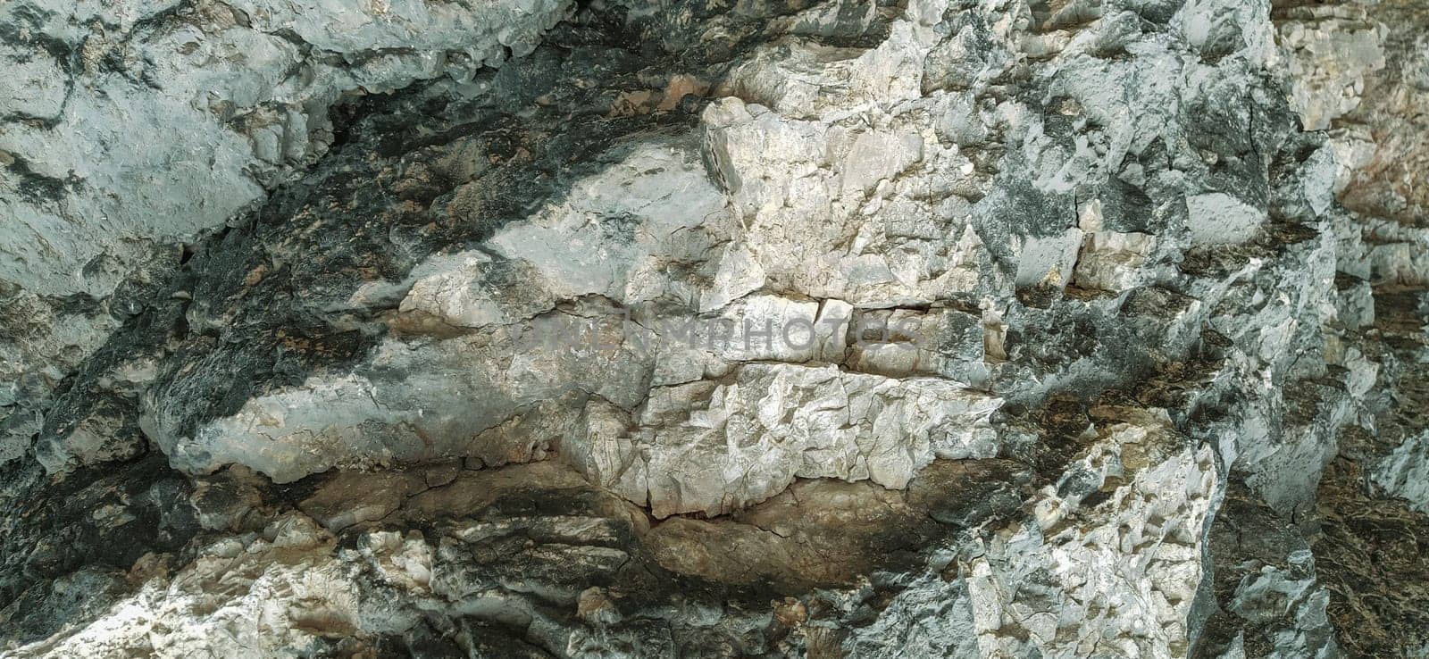 stone rock closeup in Sarajevo, Bosnia and Herzegovina. Ancient frozen lava. Layers and layers of minerals and rocks. Texture stone. Gray, green and beige colors