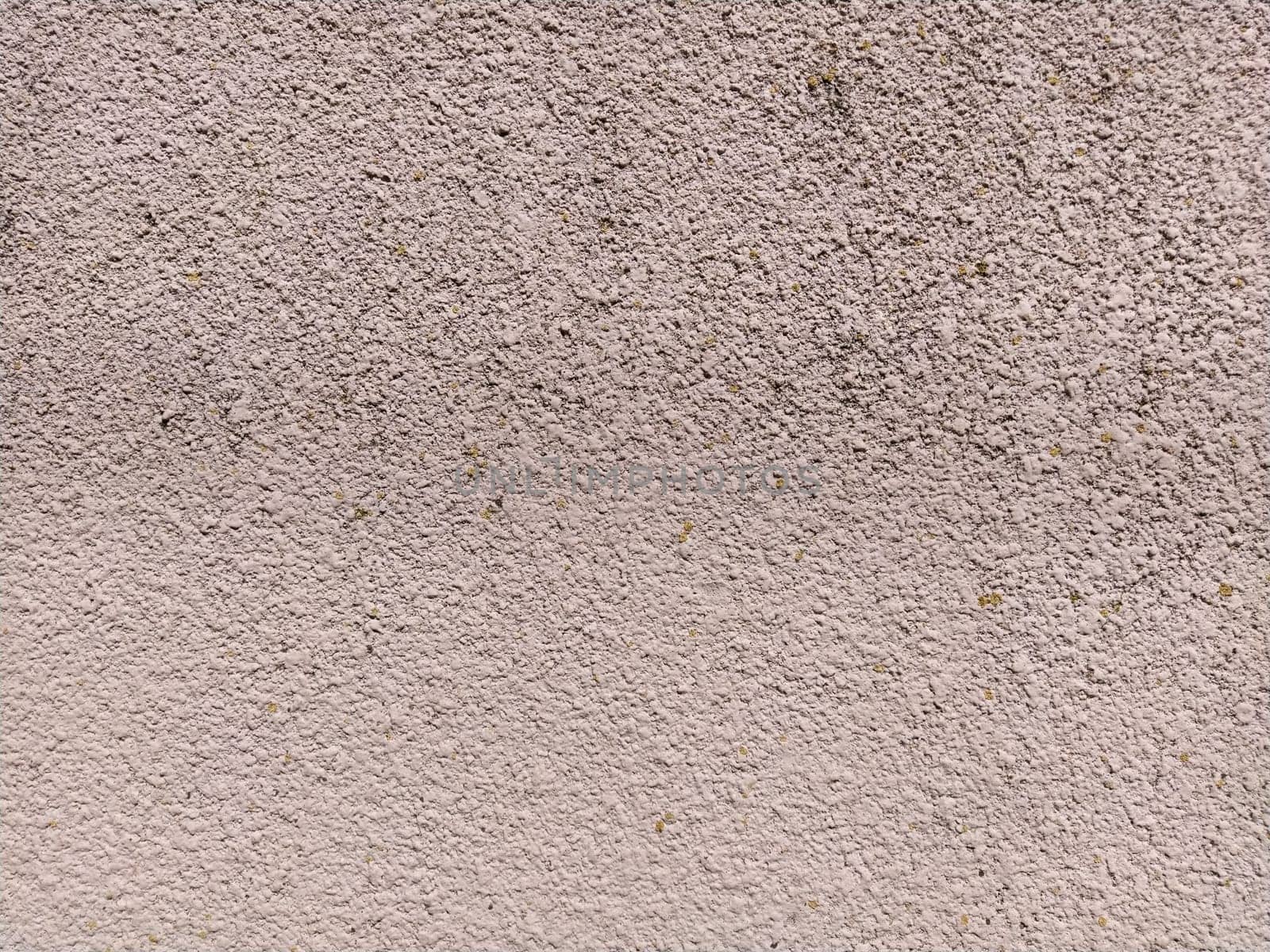 Uneven rough pink concrete wall. Background or texture.
