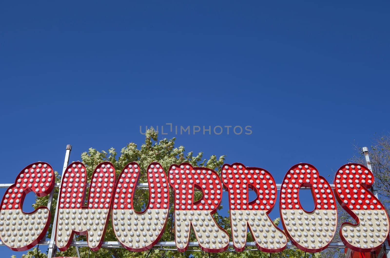 Churros fair stall banner. Blue sky background