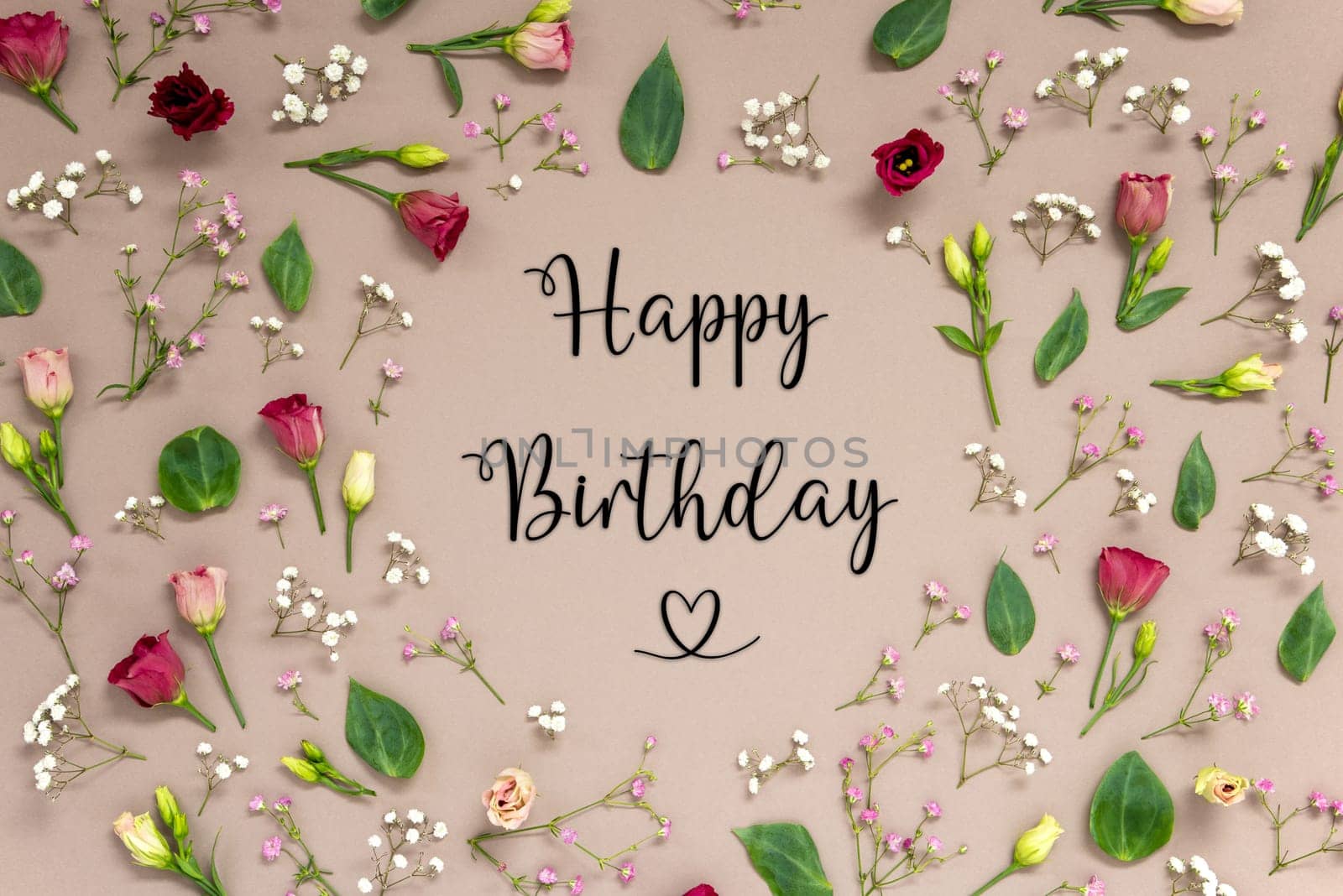 Flower Arrangement With English Text Happy Birthday. Colorful Spring Blossoms And Flowers Like Roses Building A Frame. Flat Lay With Brown Paper Background