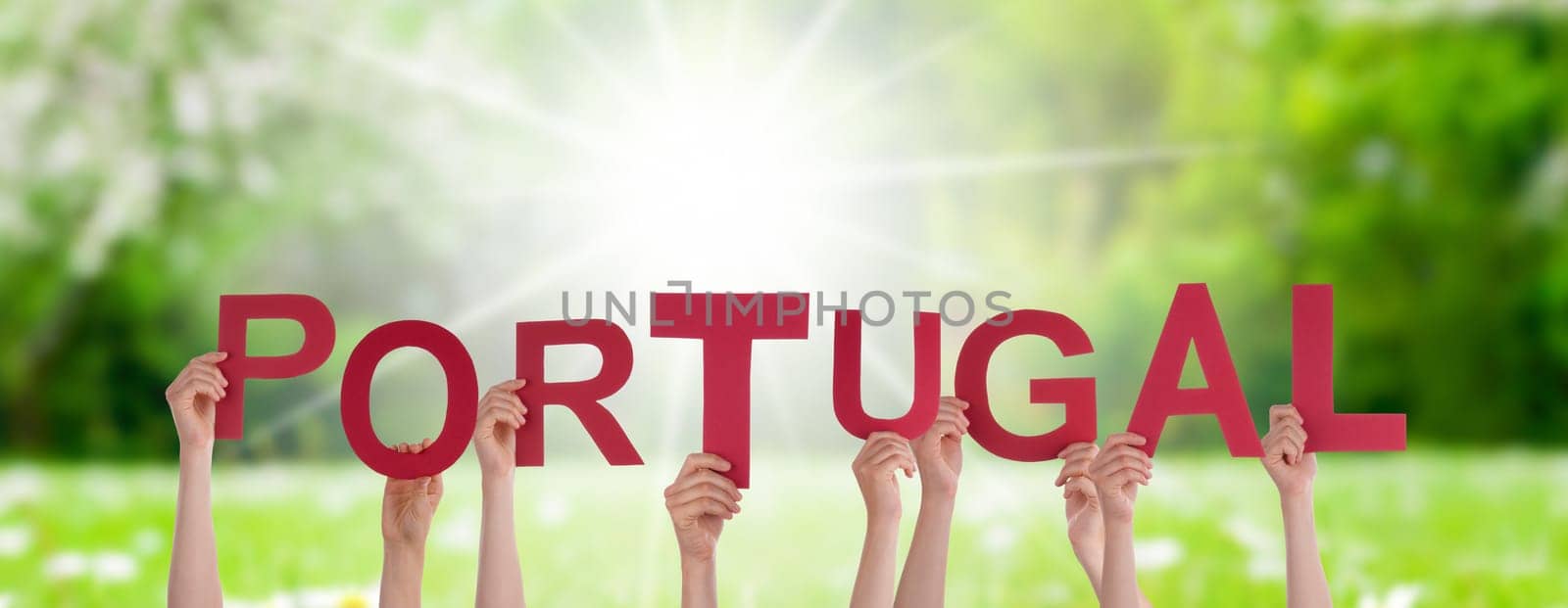 People Or Persons Hands Building English Word Portugal. Sunny Green Grass Meadow As Background.