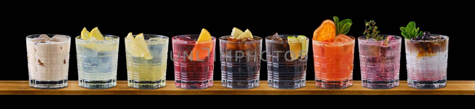 Set of multicolored summer refreshing soft drinks on black background