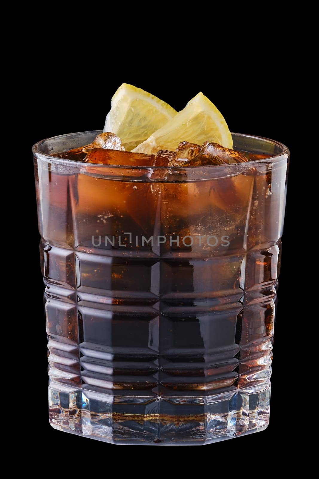 Glass of refreshing cold cola with ice isolated on black