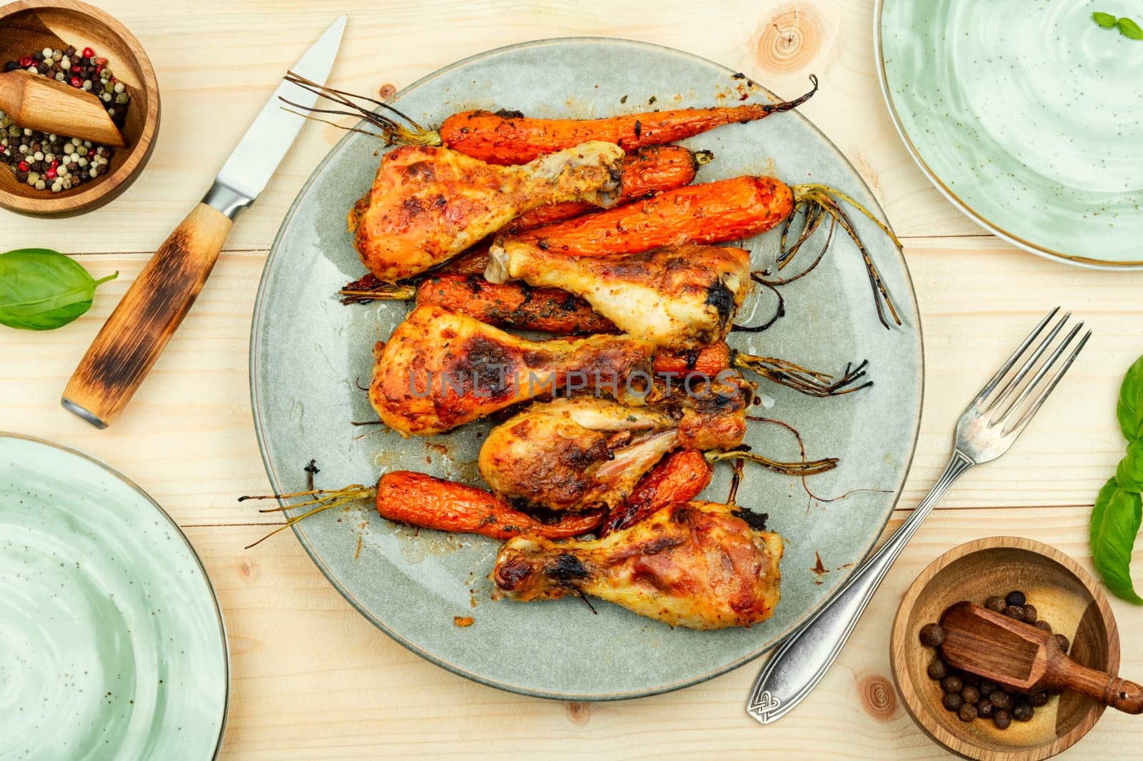 Grilled chicken drumsticks, roast chicken legs with carrots. Space for text.