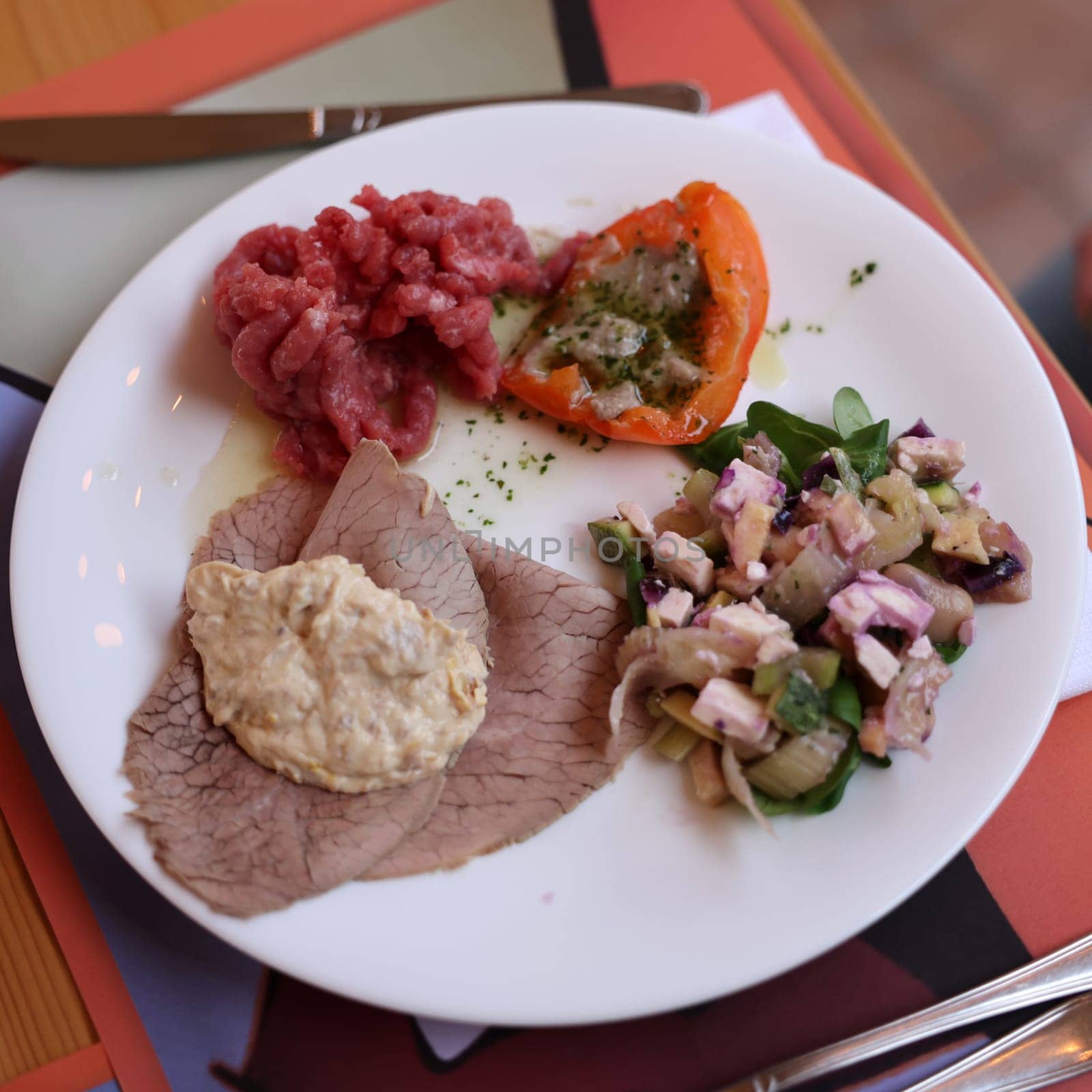 A delicious starter from Piedmont. Steak tartare, carpaccio, stuffed peppers, and salad