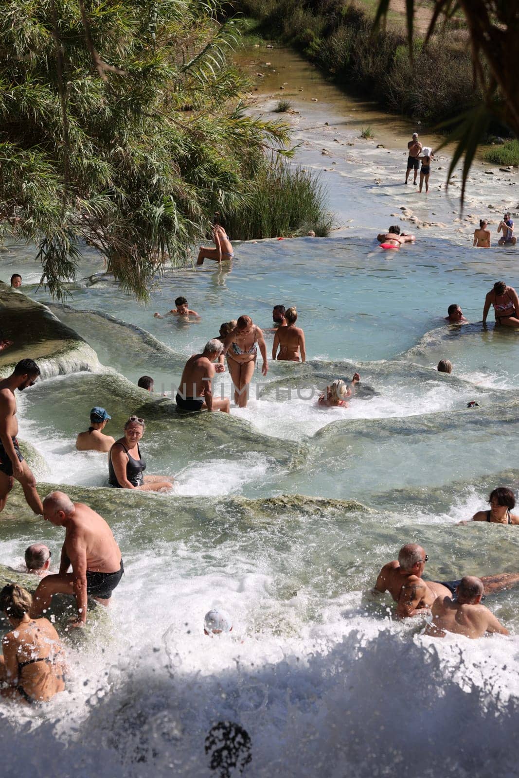 Saturnia, Italy - September 13, 2022:  People are bathing in the hot springs of Saturnia Therme, Saturnia, Tuscany, Italy