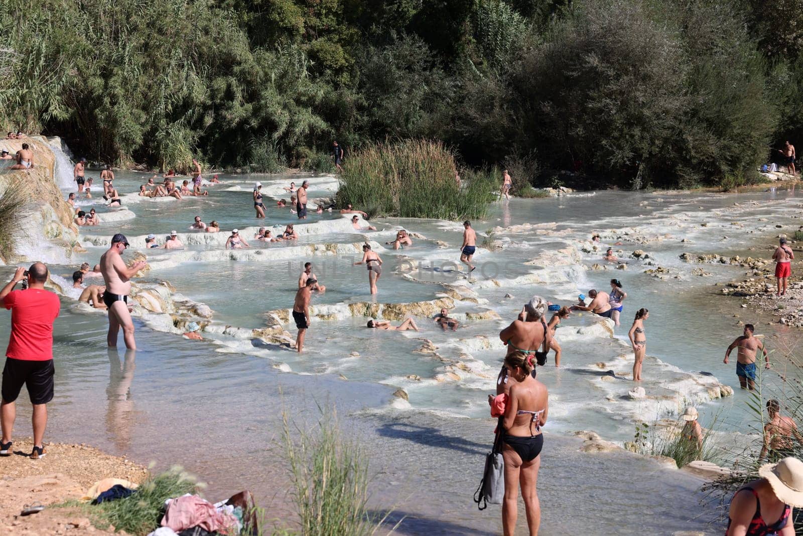 Saturnia, Italy - September 13, 2022:  People are bathing in the hot springs of Saturnia Therme, Saturnia, Tuscany, Italy