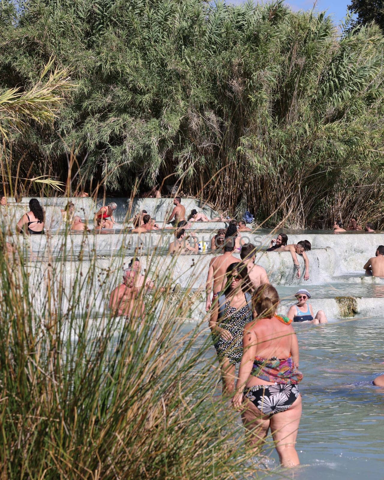 Saturnia, Italy - September 13, 2022:  People are bathing in the hot springs of Saturnia Therme, Saturnia, Tuscany, Italy