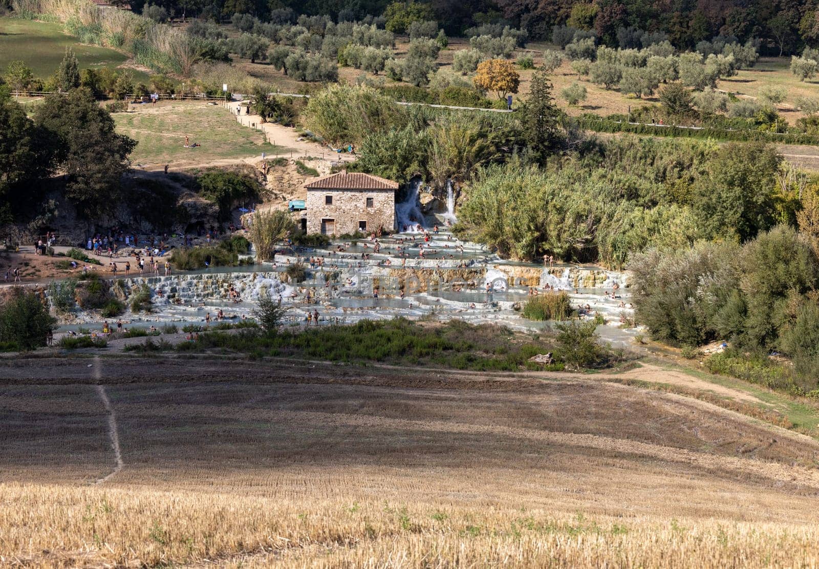 Saturnia, Italy - September 13, 2022:  People are bathing in the hot springs of Saturnia Therme, Saturnia, Tuscany, Italy
