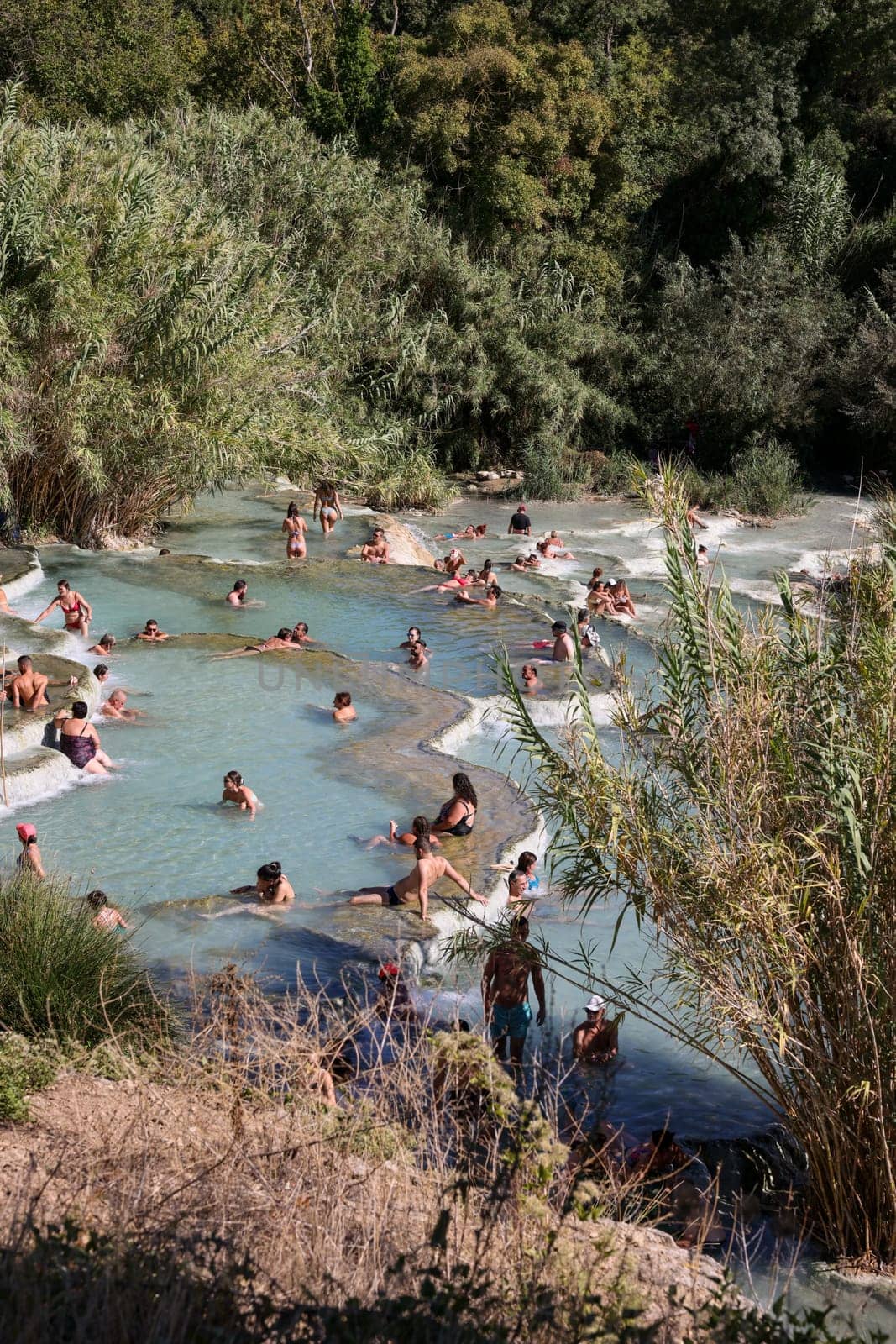 Saturnia, Italy - September 13, 2022:  People are bathing in the hot springs of Saturnia Therme, Saturnia, Tuscany, Italy