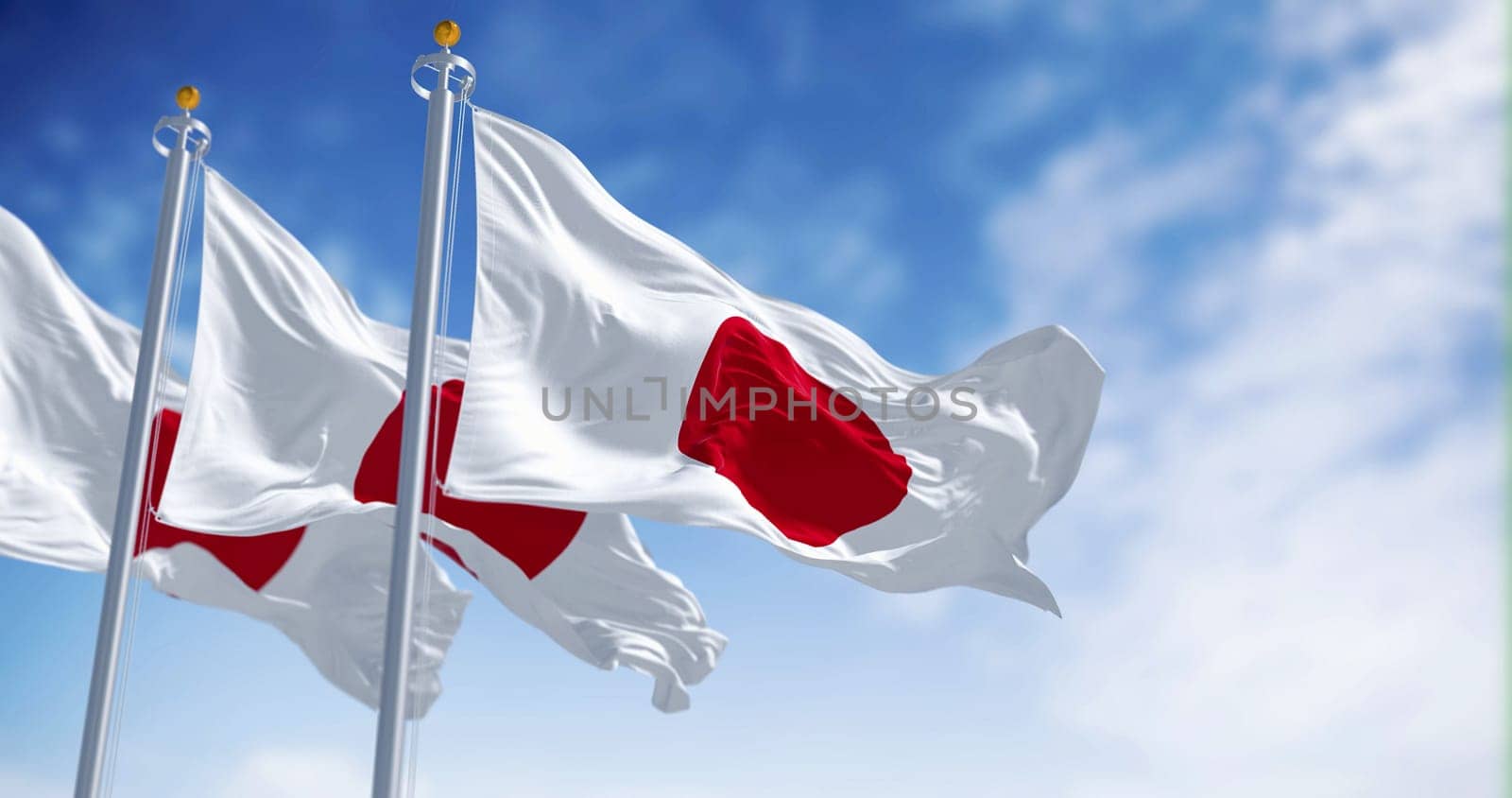 Three Japan national flags waving in the wind on a clear day. Red disc on a white field. Japan is an island country in East Asia. 3D illustration render. Rippled textile