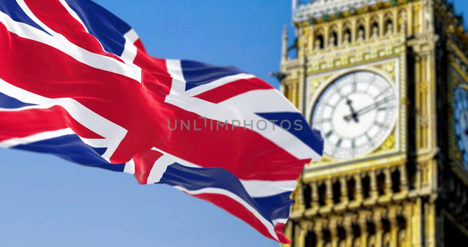 National flag of the United Kingdom waving in the wind with blurred Big Ben on the background. 3D illustration render. Rippled textile. Selective focus