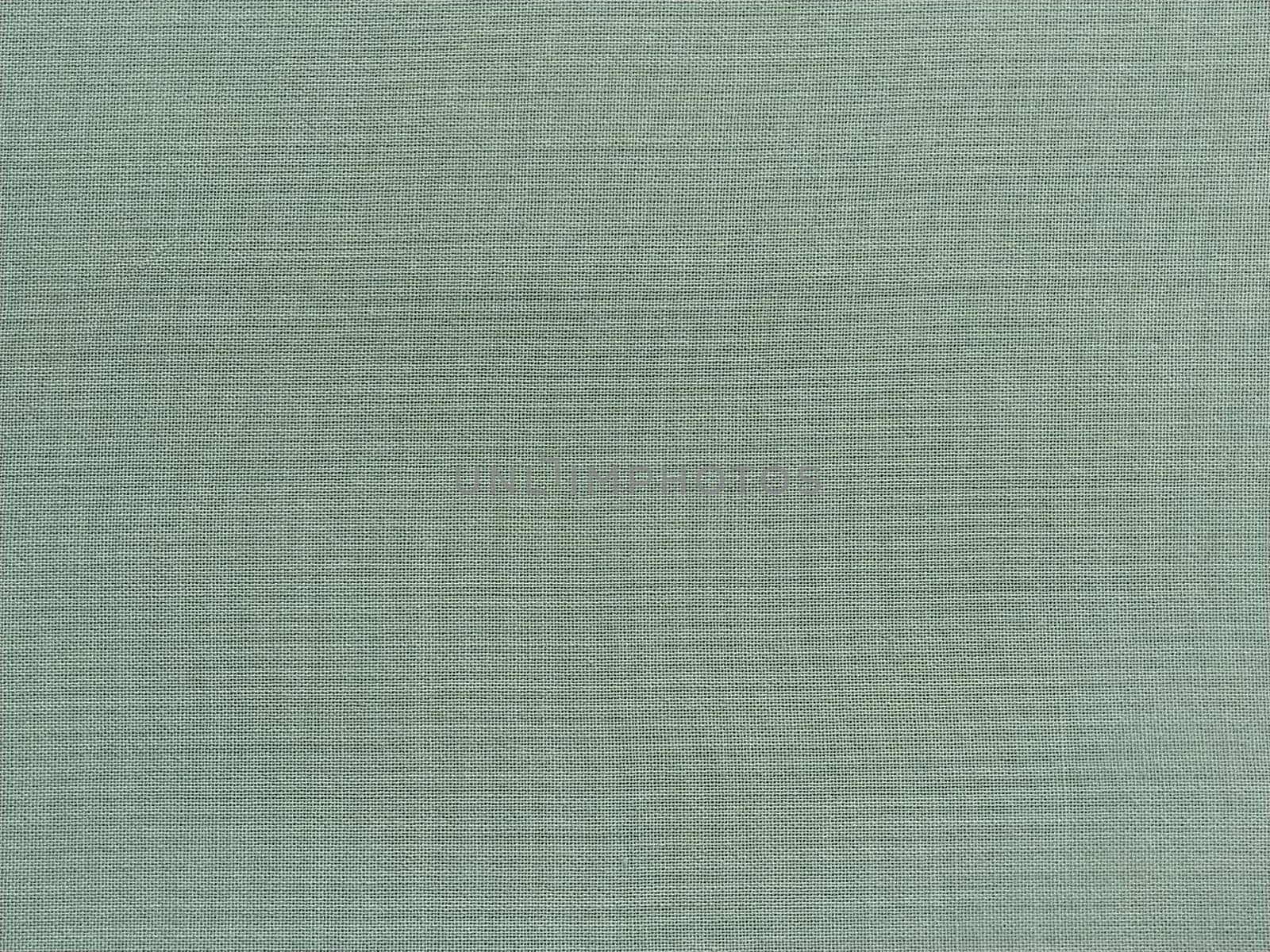 light green fabric. A piece of woolen fabric laid out neatly on the surface. Interlacing and textile texture. dress fabric or for kitchen needs, tablecloth or curtains.