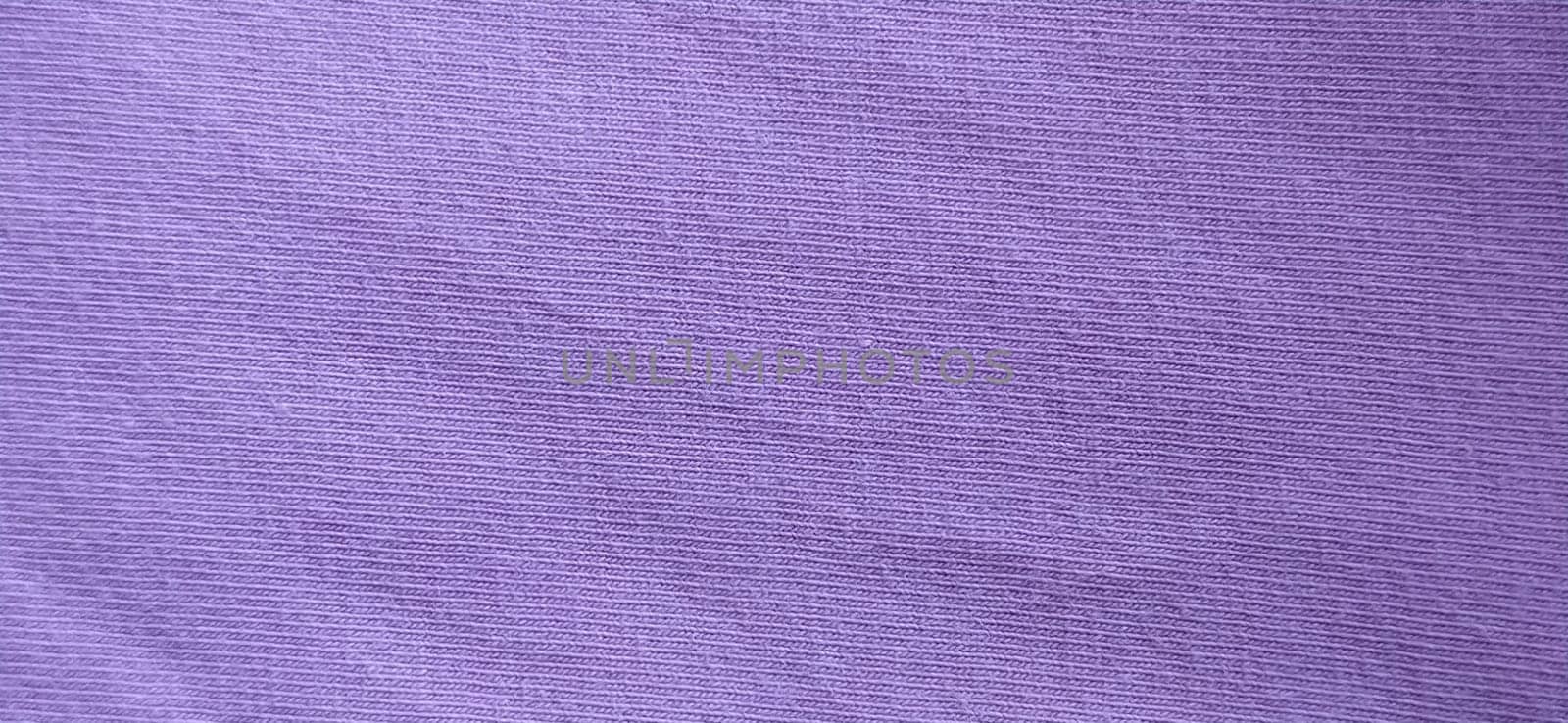 Crumpled pink cotton fabric. Close-up. Fabric texture.