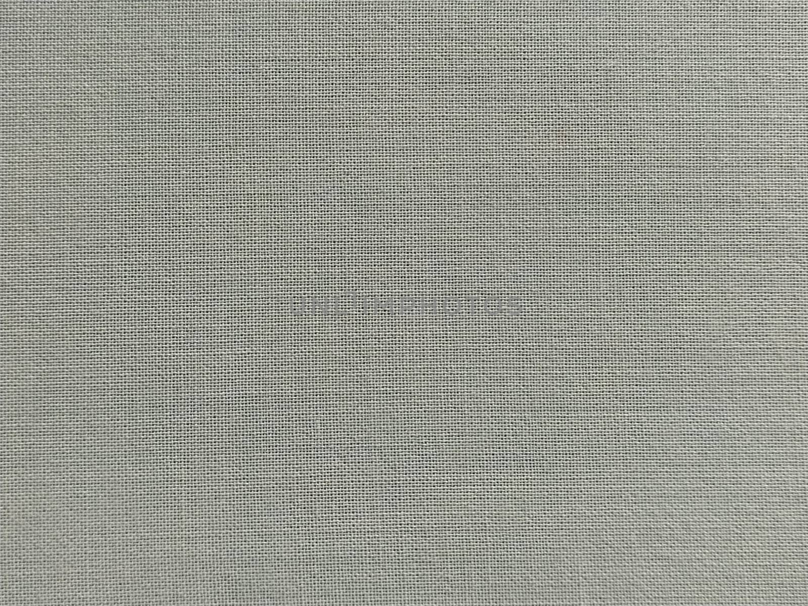 pale light green fabric. A piece of woolen fabric laid out neatly on the surface. Interlacing and textile texture. dress fabric or for kitchen needs, tablecloth or curtains.