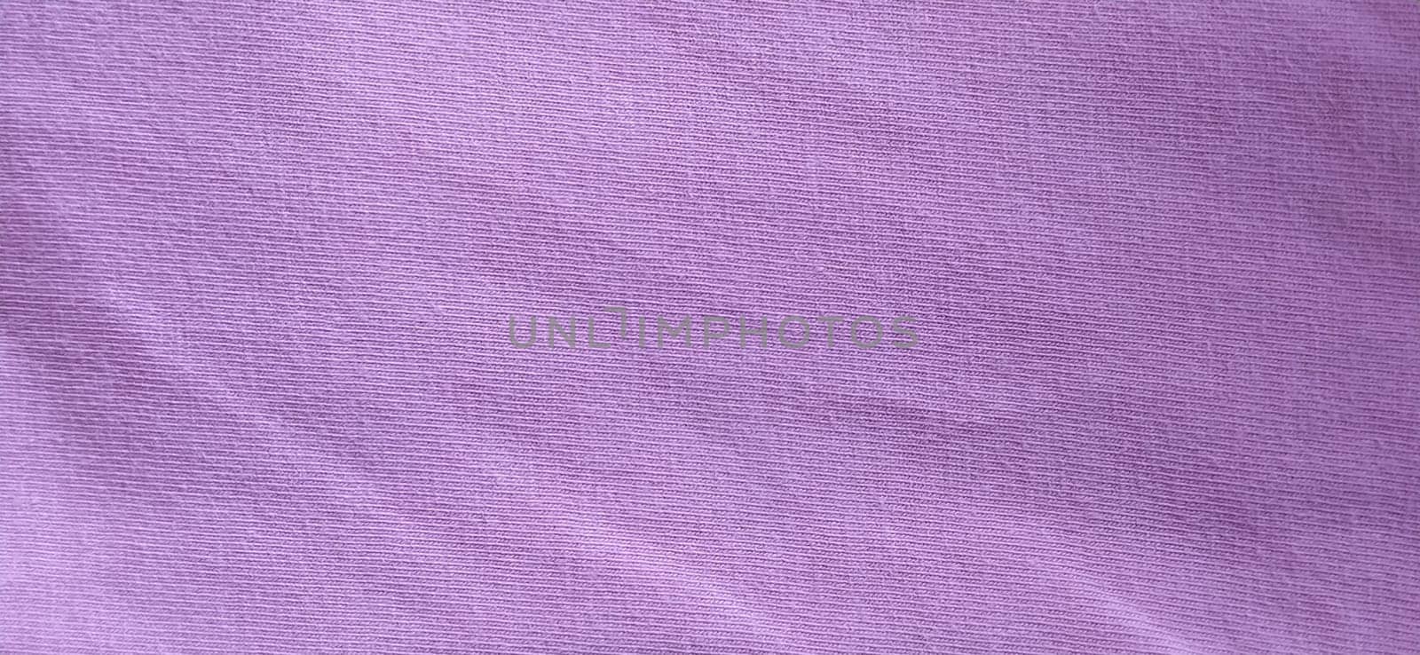 Crumpled pink cotton fabric. Close-up. Fabric texture.