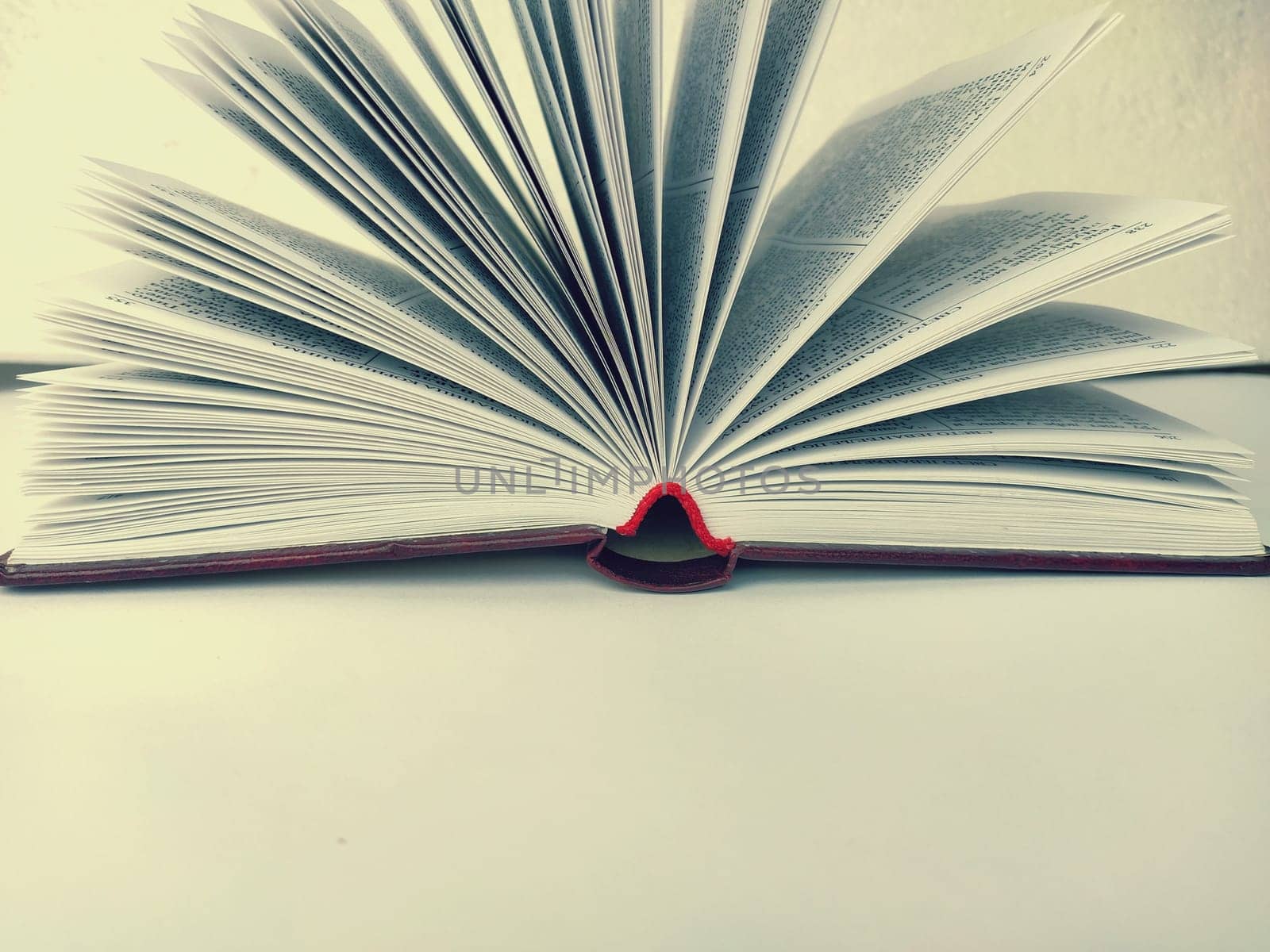 the opened book on the white table.