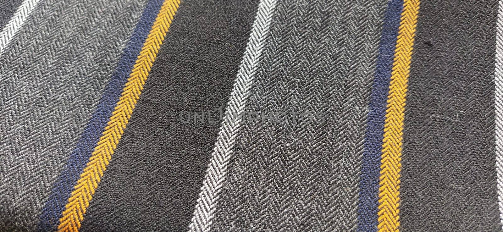 Light fabric with orange and dark blue stripes. Interior decoration. Dress fabrics in casual style. Dense material for indoor curtains and furniture finishing.
